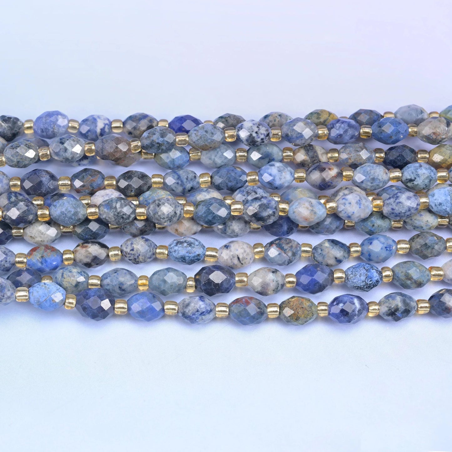 Faceted rice barrel cut sunset dumortierite beads