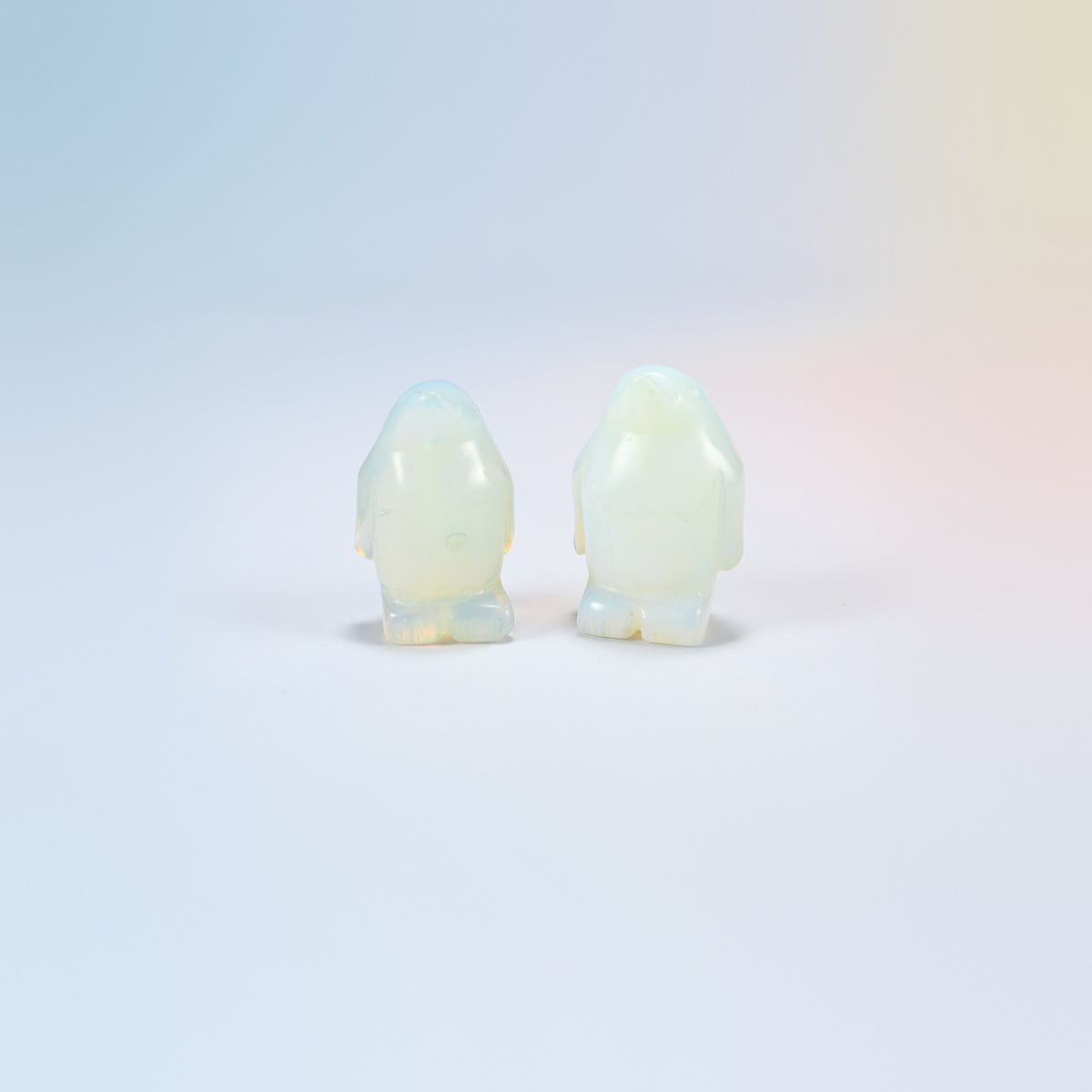 Two opalite penguin crystal carvings, 1.5 inch, glowing milky white man-made glass