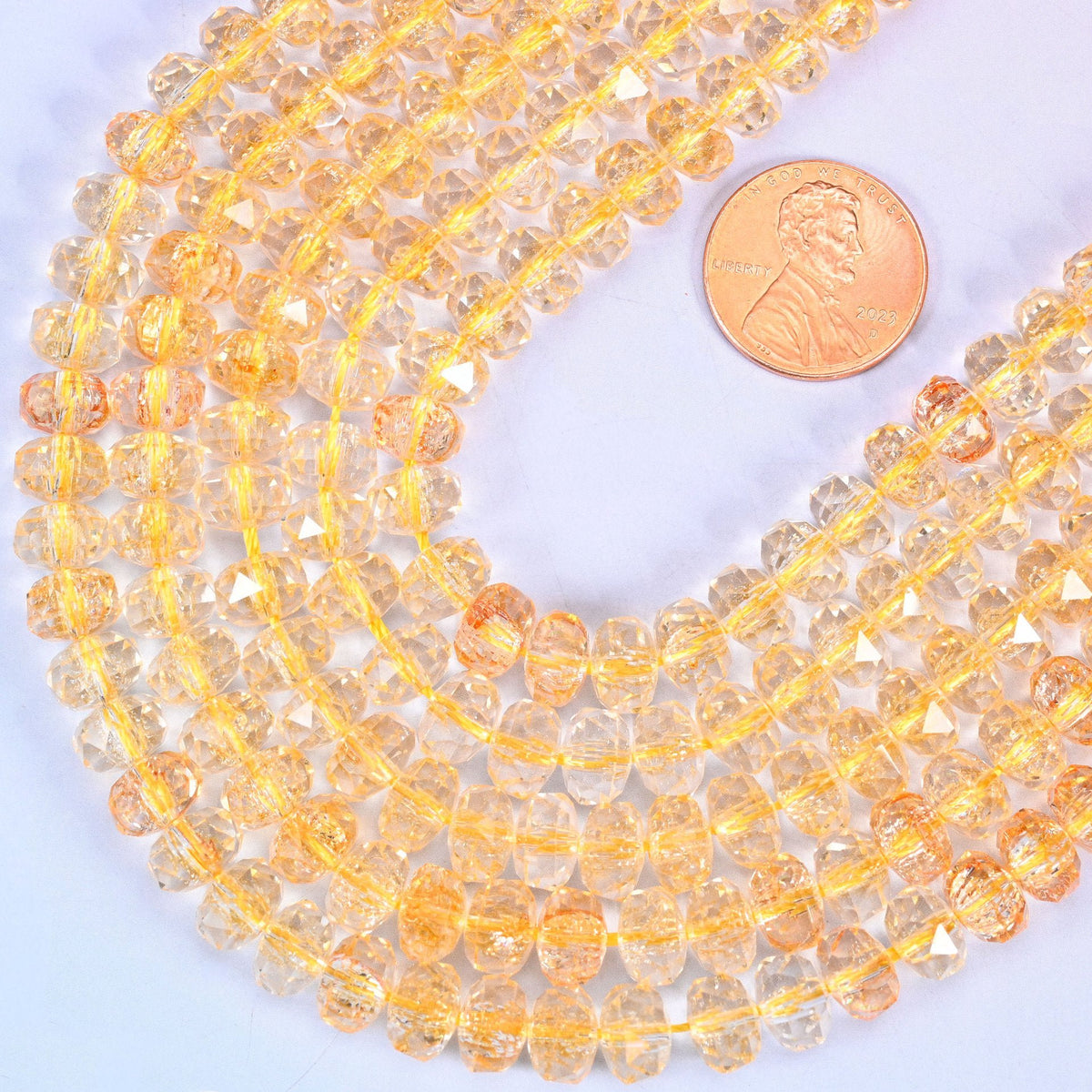 Faceted rondelle cut transparent gold glass beads