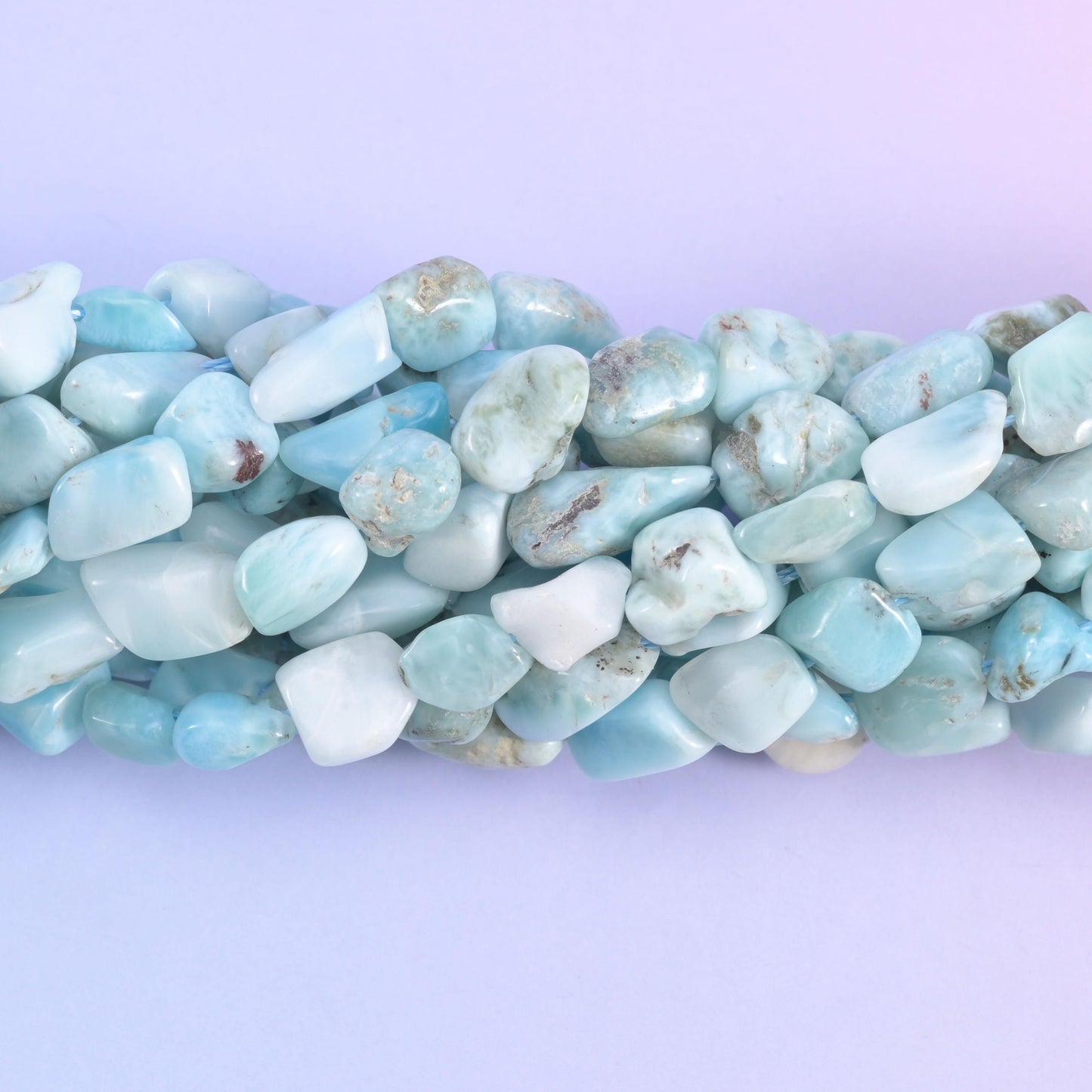 Macro of the polished nugget faces, powder blue marked with grey-tan matrix flecks