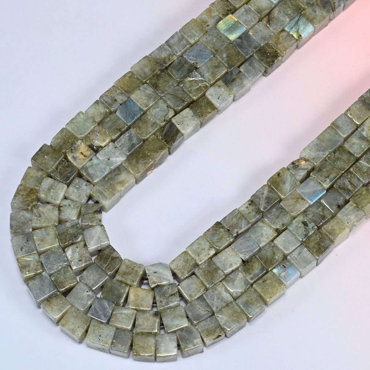 Gray Labradorite cube beads curving in a long loop, blue flash appearing in blocks across the flat faces