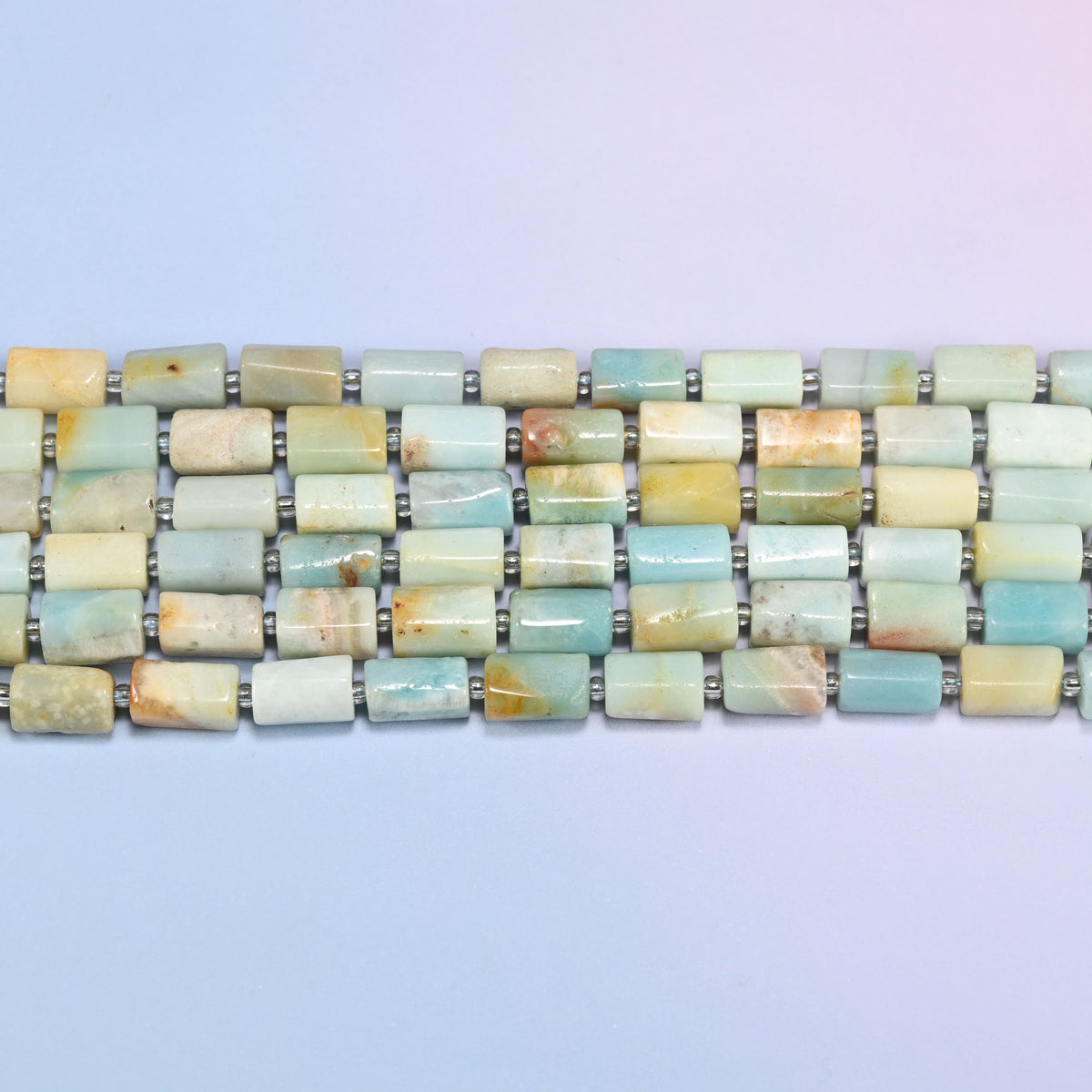 Side view of Multi-Color Amazonite faceted tube beads laid straight in two rows, showing the flat polished planes and brown and orange markings