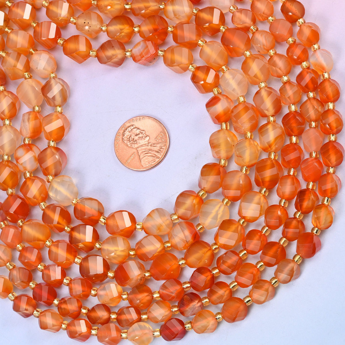 Natural banded carnelian, some beads deep solid orange, others streaked with cream