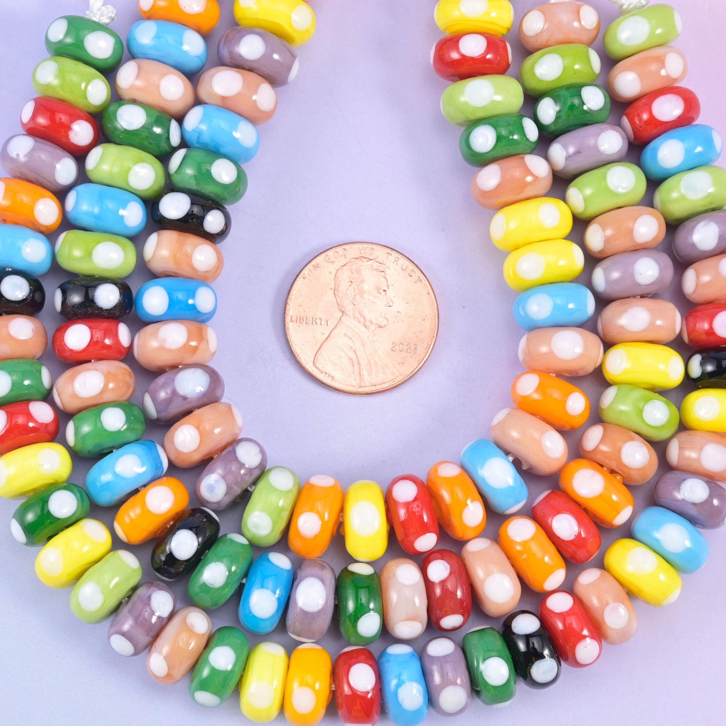 Multi-Color Donut Glass Beads, chunky opaque glass rondelles dotted with small white spots so the strand reads like painted candy
