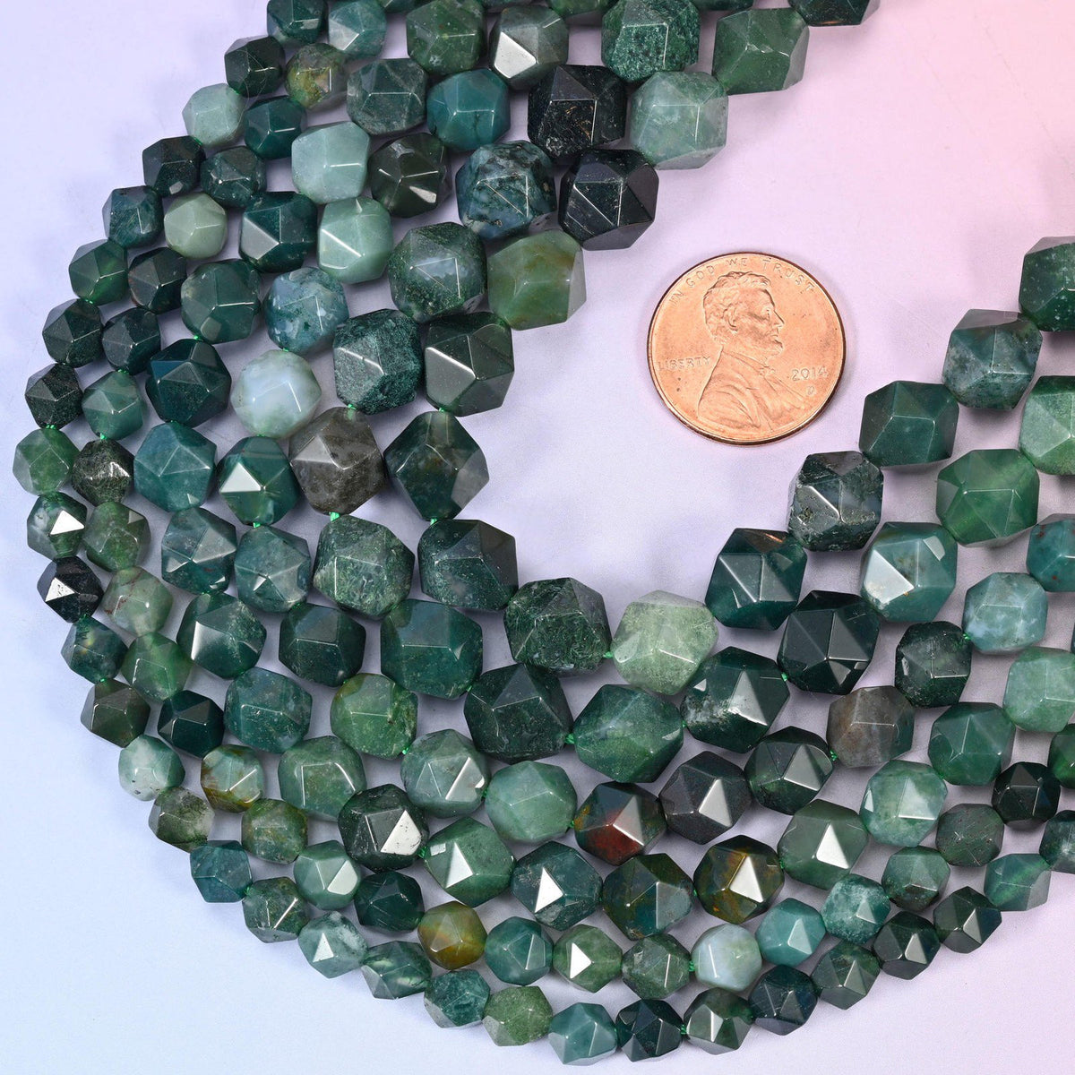Moss Agate star cut beads with a US penny alongside for size reference, available in 6mm, 8mm and 10mm