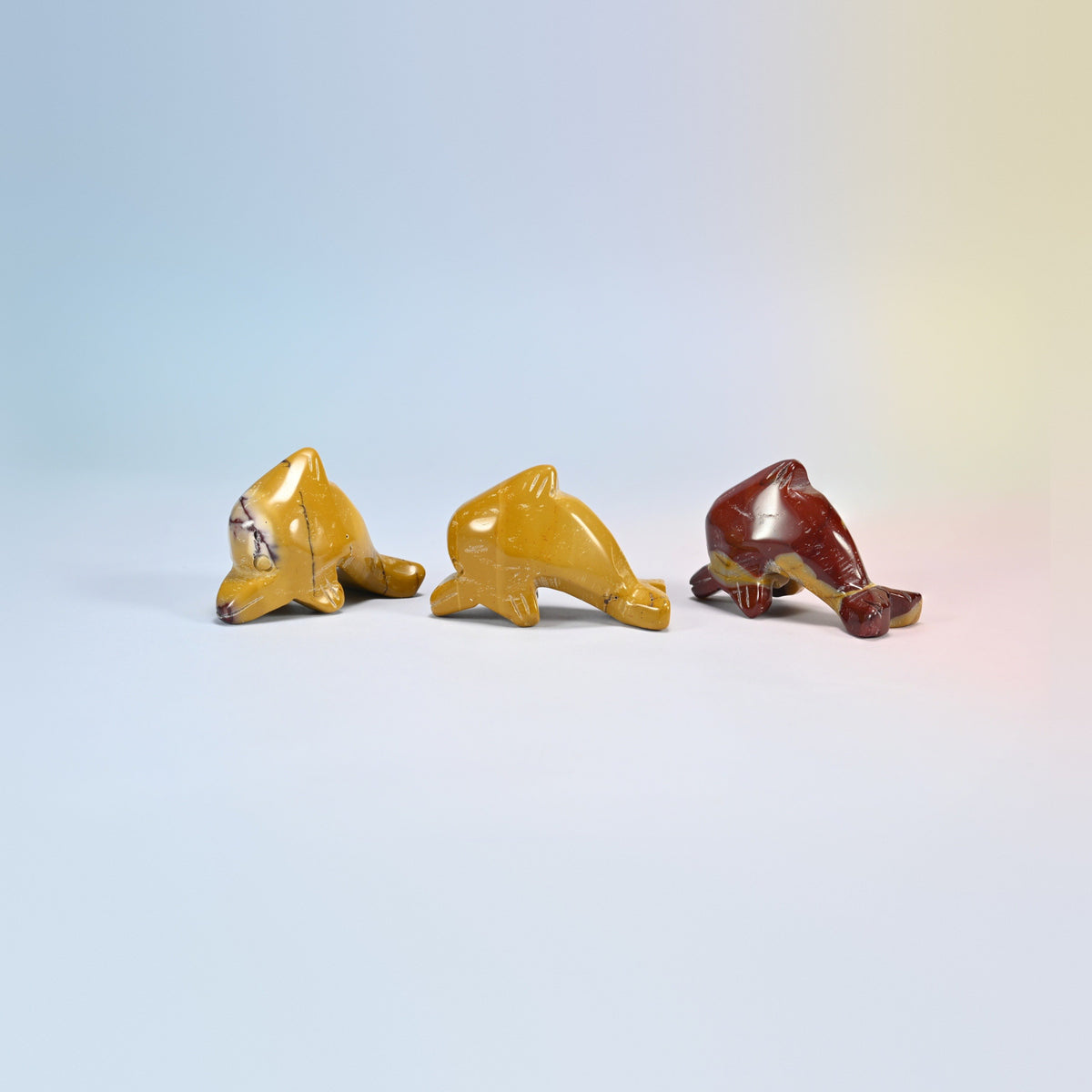 Three mookaite dolphin crystal carvings, 2 inch, golden yellow and deep red natural stone