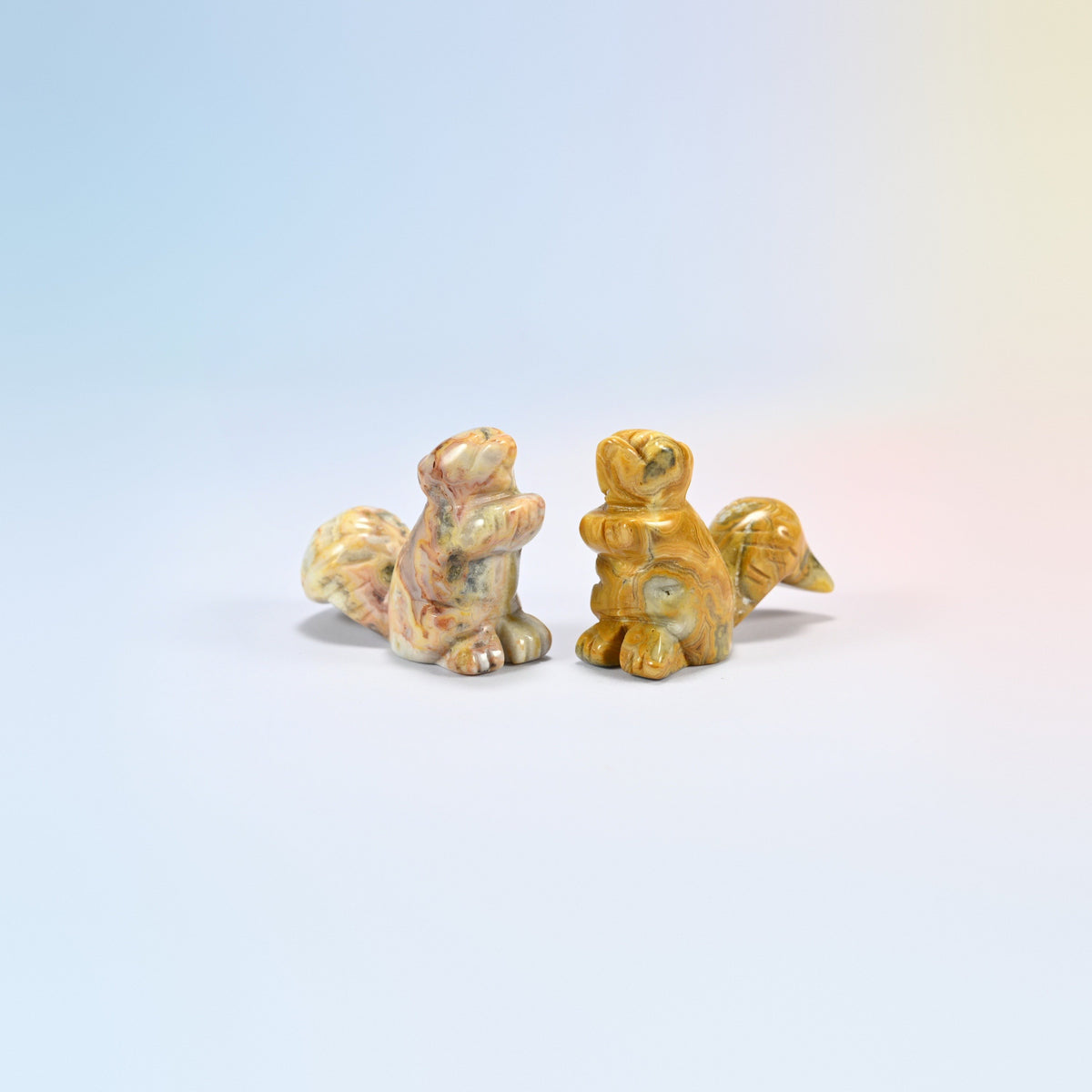 Two 2 inch natural crazy agate long tail squirrel carvings, cream, tan and yellow patterned agate