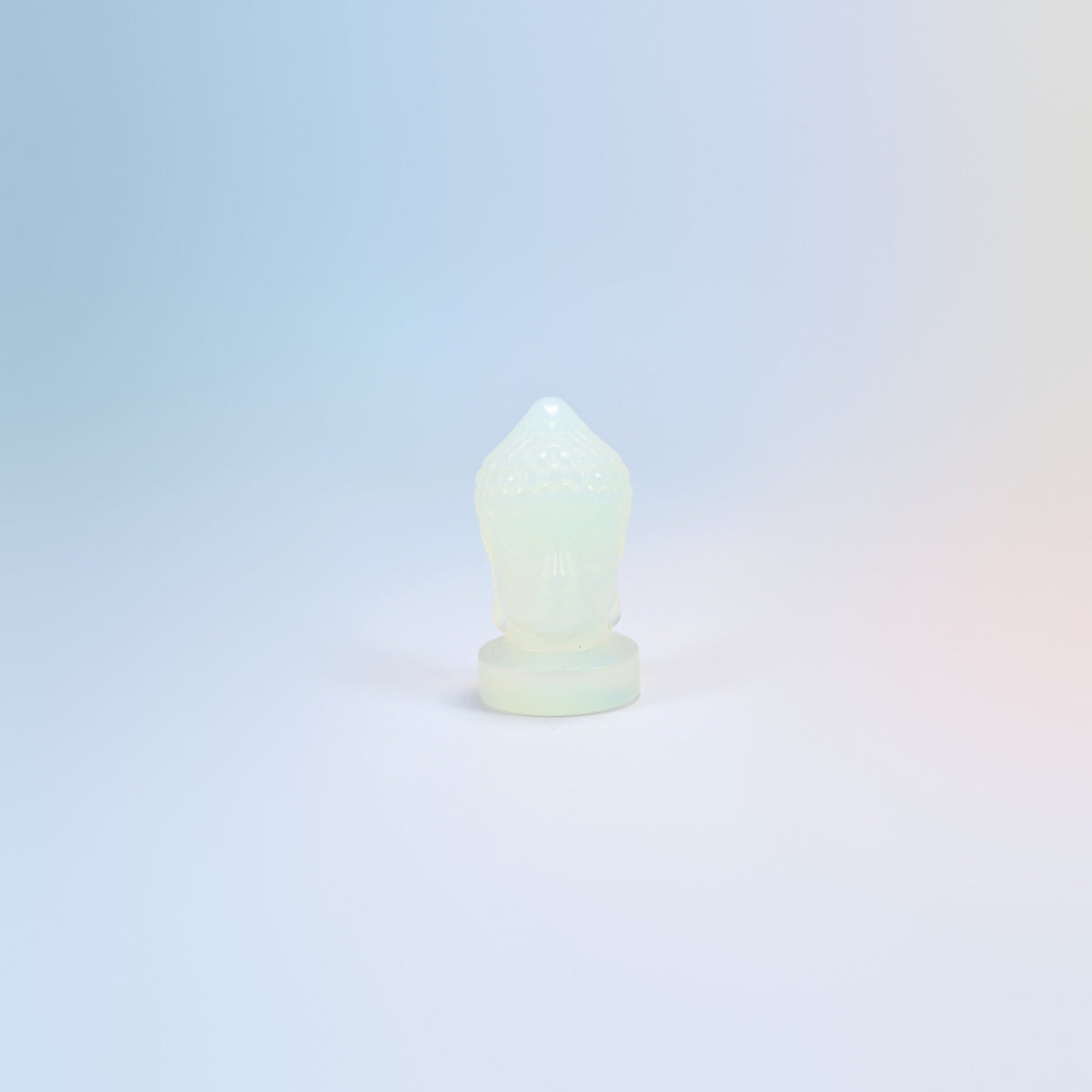 Opalite Buddha head carving, 2 inch, milky white with a soft blue glow, man-made glass