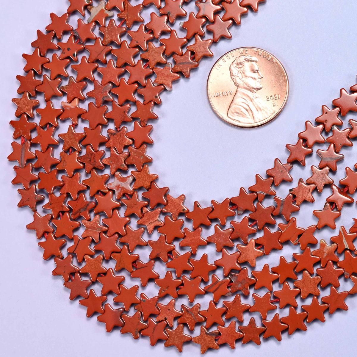 Flat star cut red jasper beads