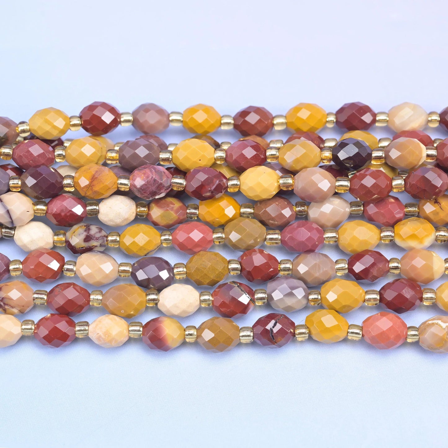 Faceted rice barrel cut mookaite jasper beads