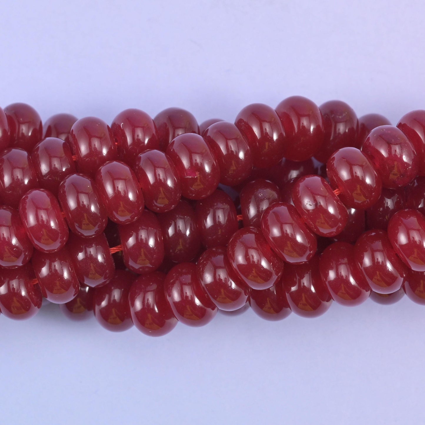 Smooth rondelle cut dyed jade beads with a polished surface