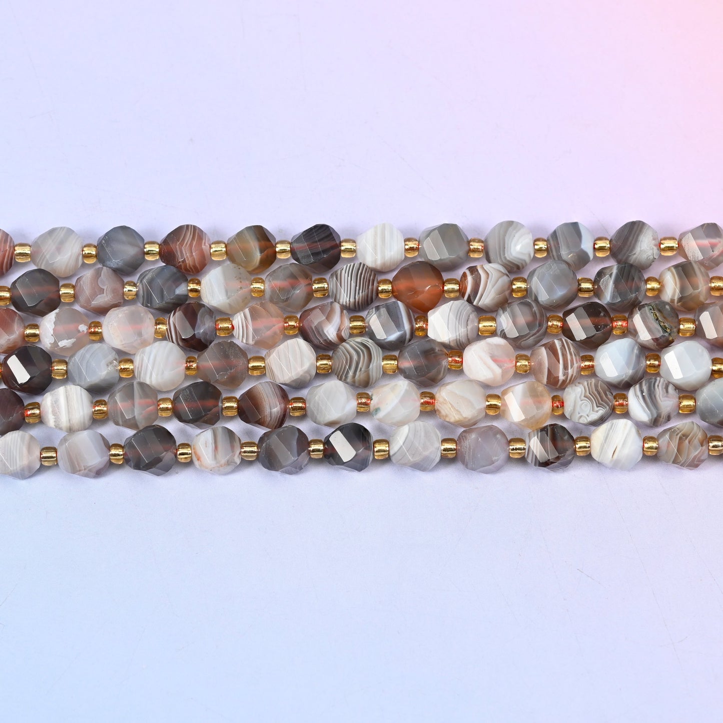 Botswana agate natural stone beads with warm red-brown and peach beads mixed through the grey and cream strand