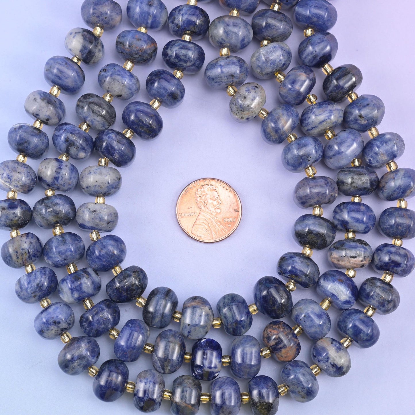 Sodalite smooth pumpkin beads in deep indigo-blue with natural white and gray veining