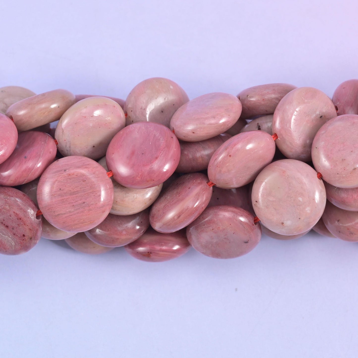 Coin cut Pink Rhodonite beads with a smooth polished finish