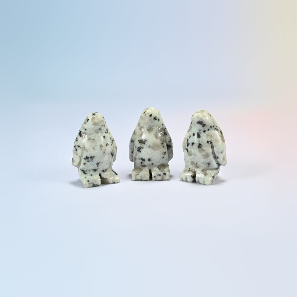 Three kiwi jasper penguin crystal carvings, 1.5 inch, cream natural stone with dark spots