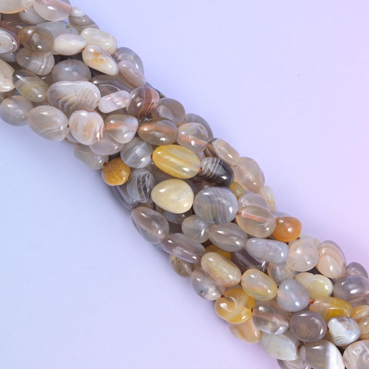 Diagonal drape of Botswana Agate pebbles showing their tumbled polish