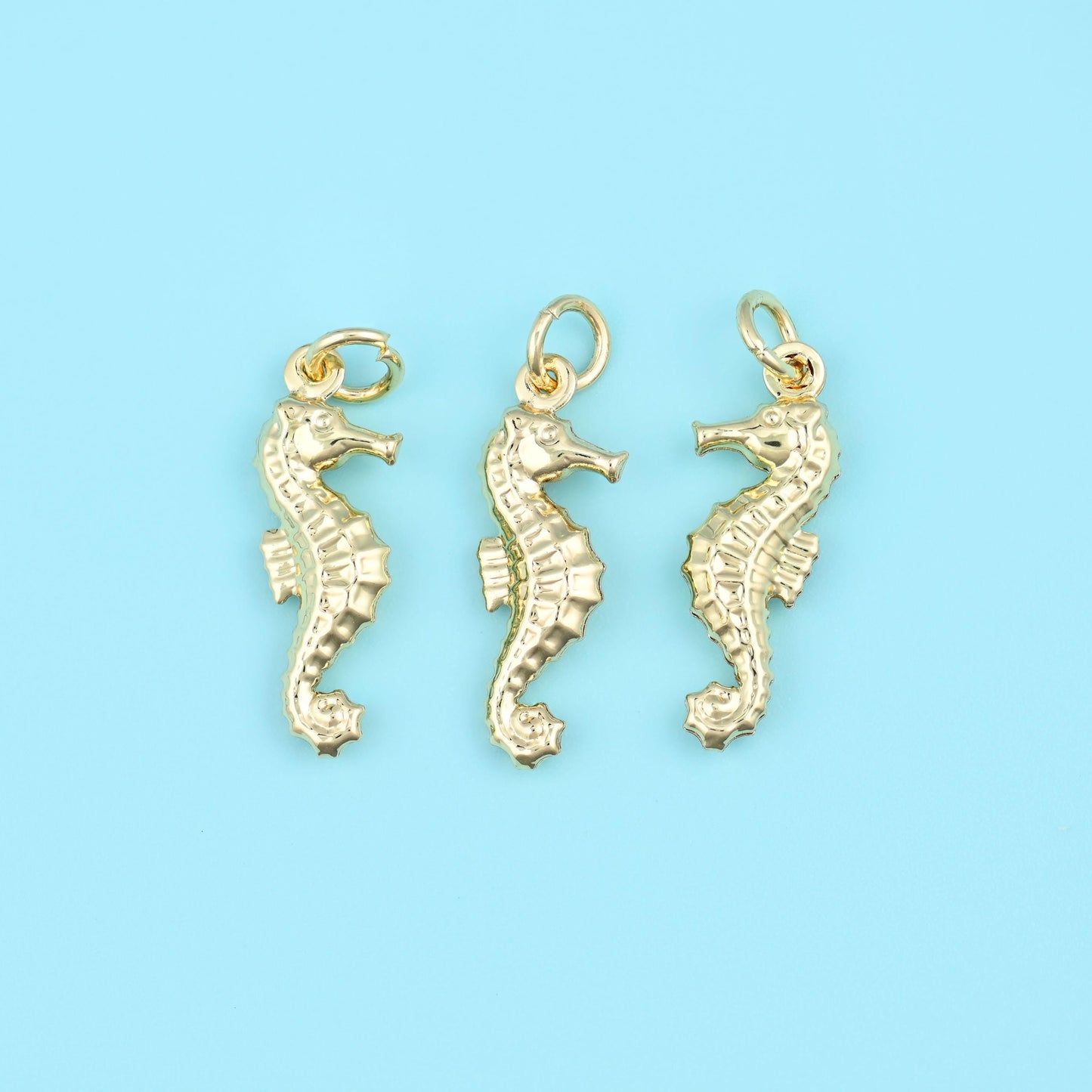 A slim gold-tone seahorse with a finely ridged body and a curled tail, cast in brass and gold filled for a warm even shine,…