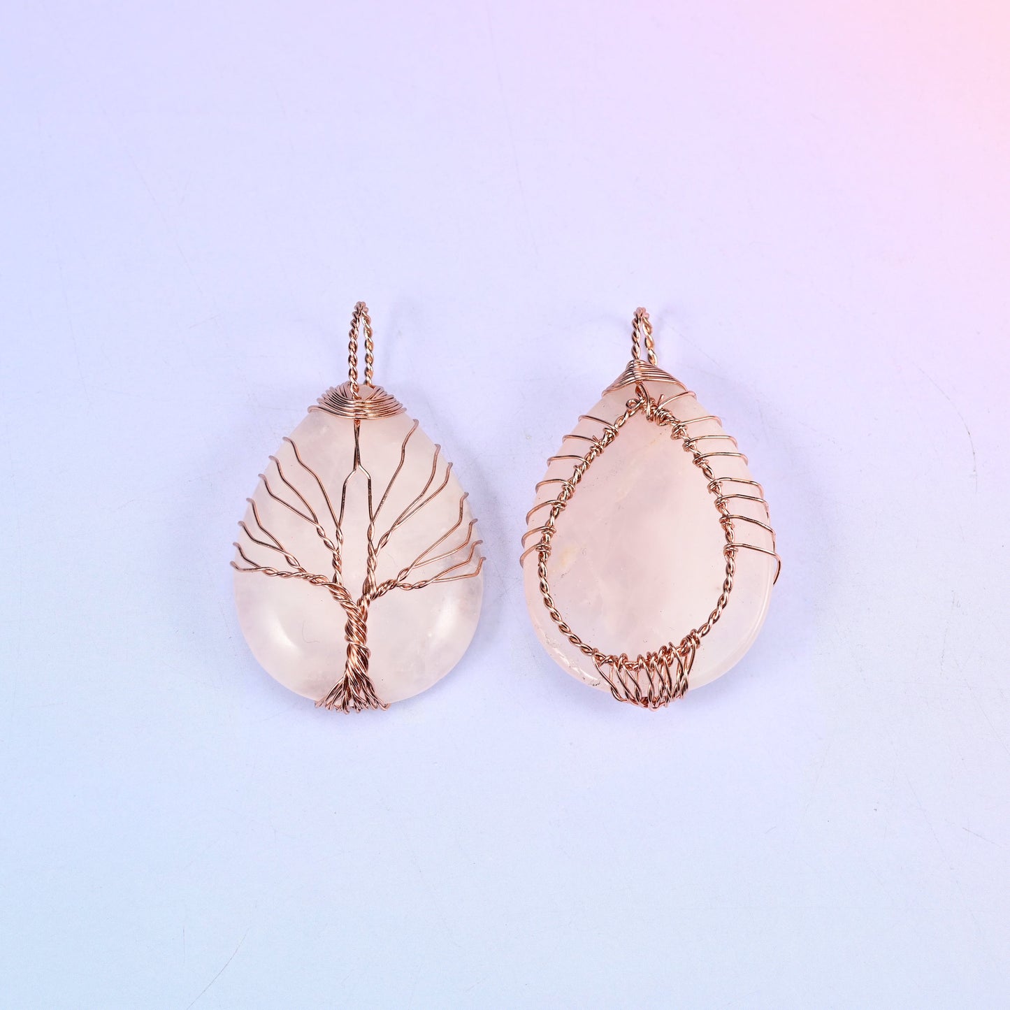 Teardrop Crystal Pendant with Copper Wired Tree in rose quartz, front and back pair with the copper wrapping visible along the edges of the stone.