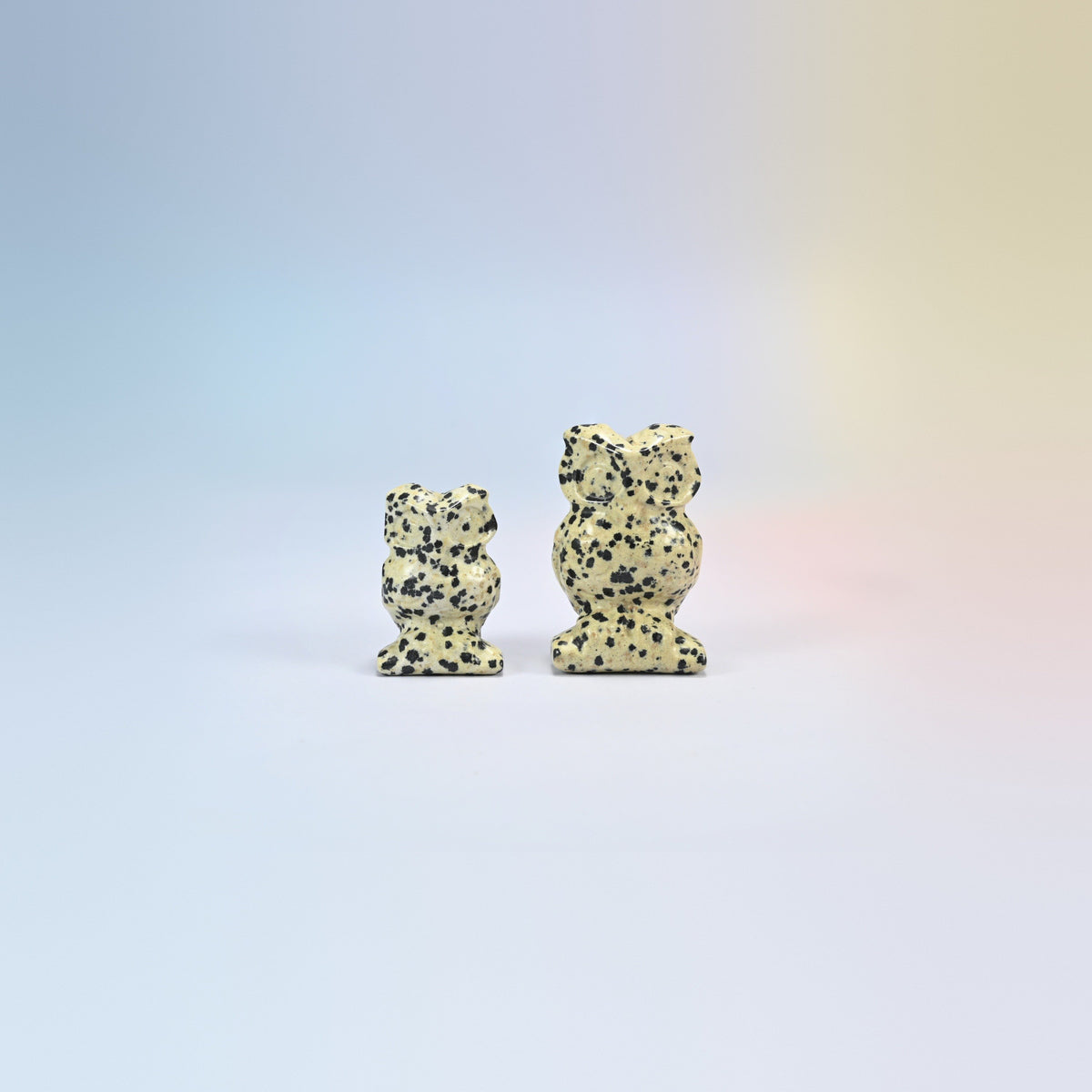 Owl crystal carving in dalmatian jasper, cream natural stone with black spots