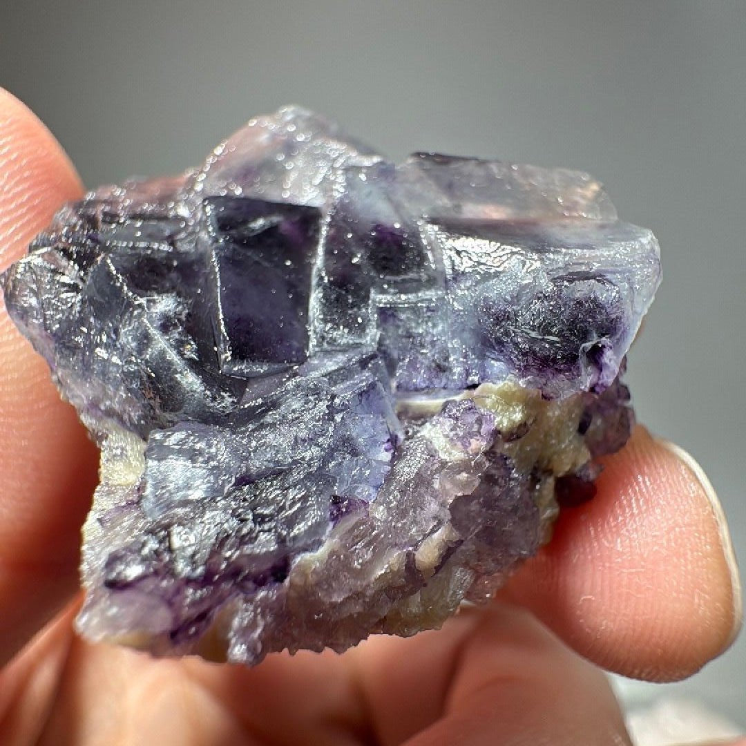Fluorite specimen turned to reveal pale calcite along one edge