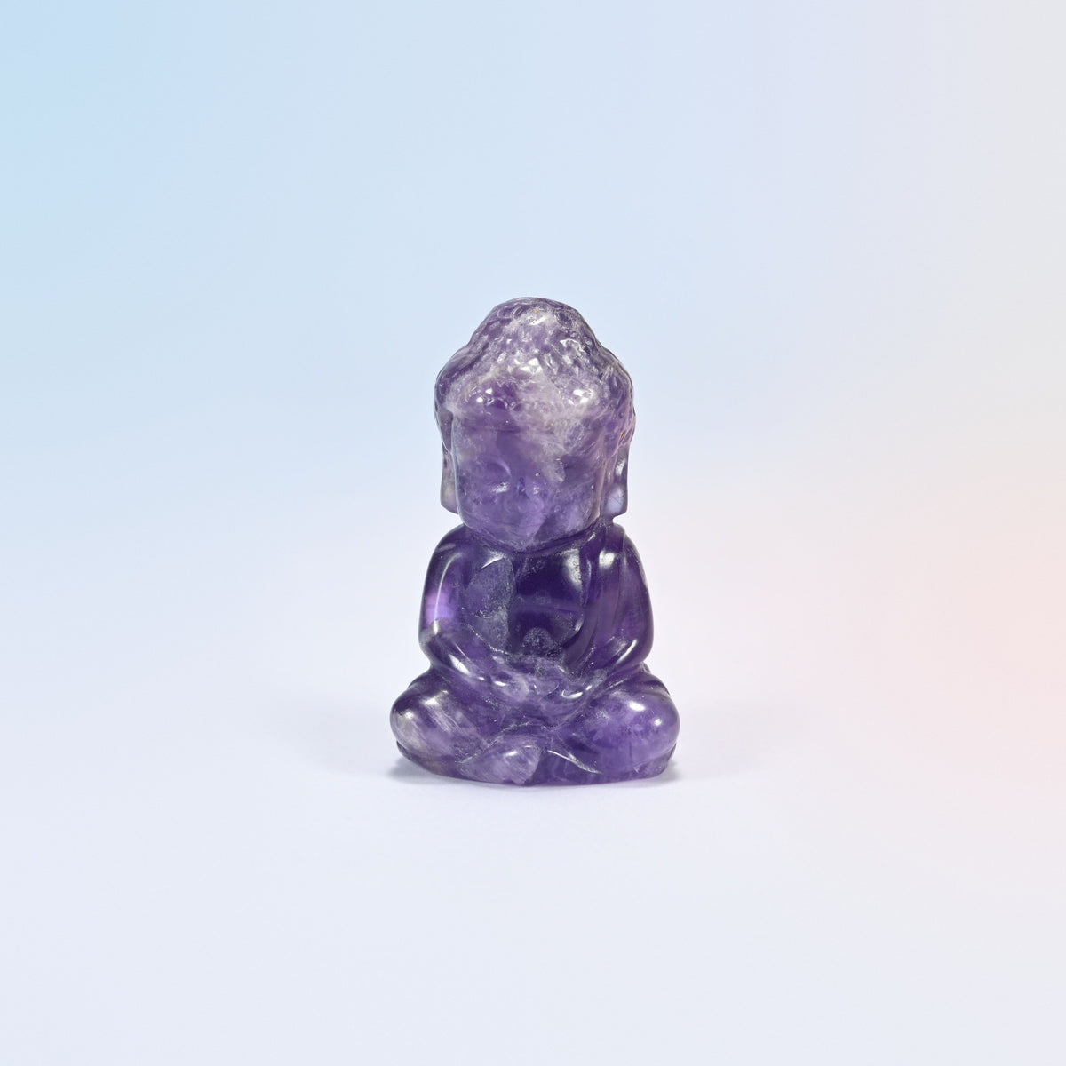 Natural amethyst sitting Buddha carving in purple with white veins, 2 inch