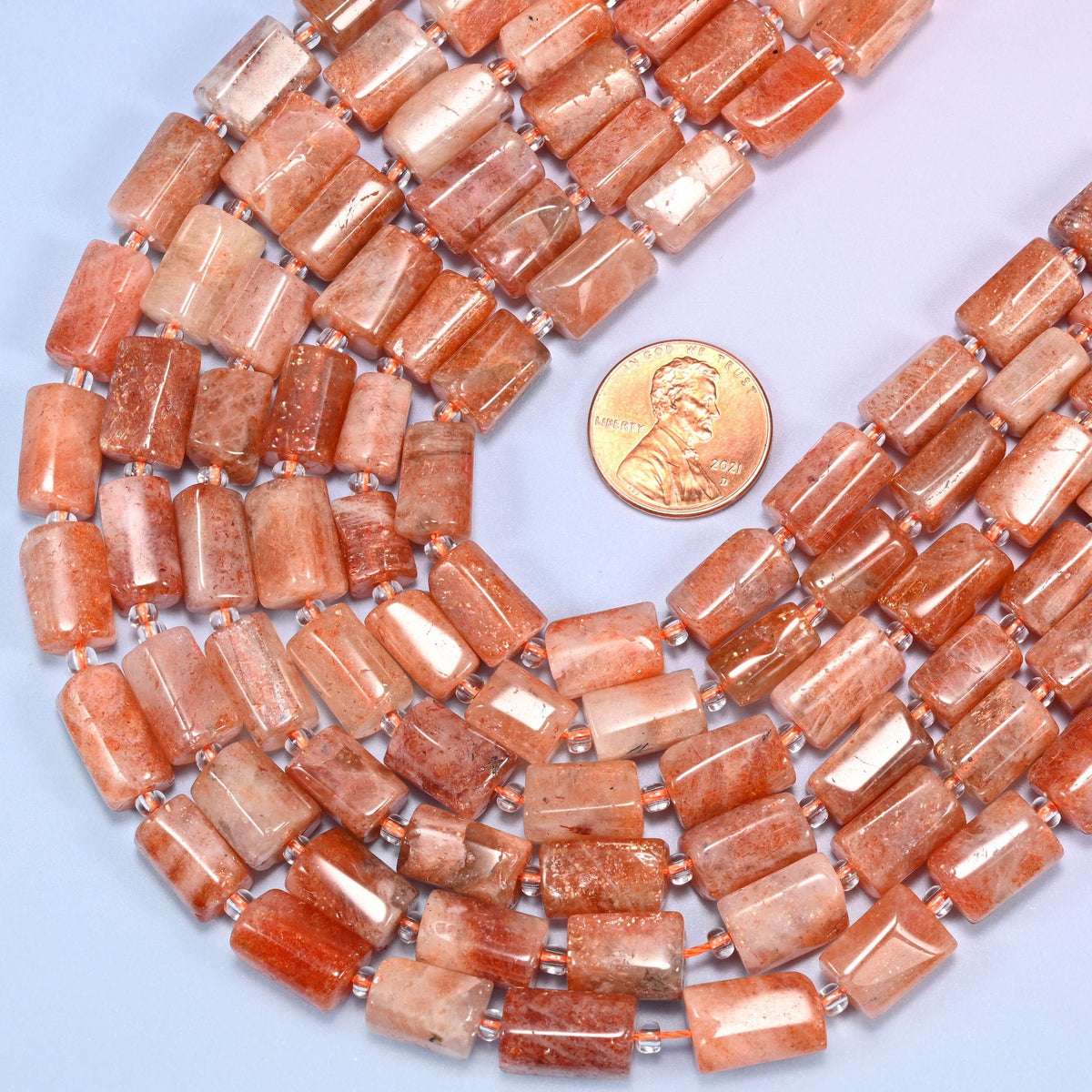 Faceted tube cut Natural Golden Strawberry Quartz beads with a 2mm clear glass spacer between each stone.
