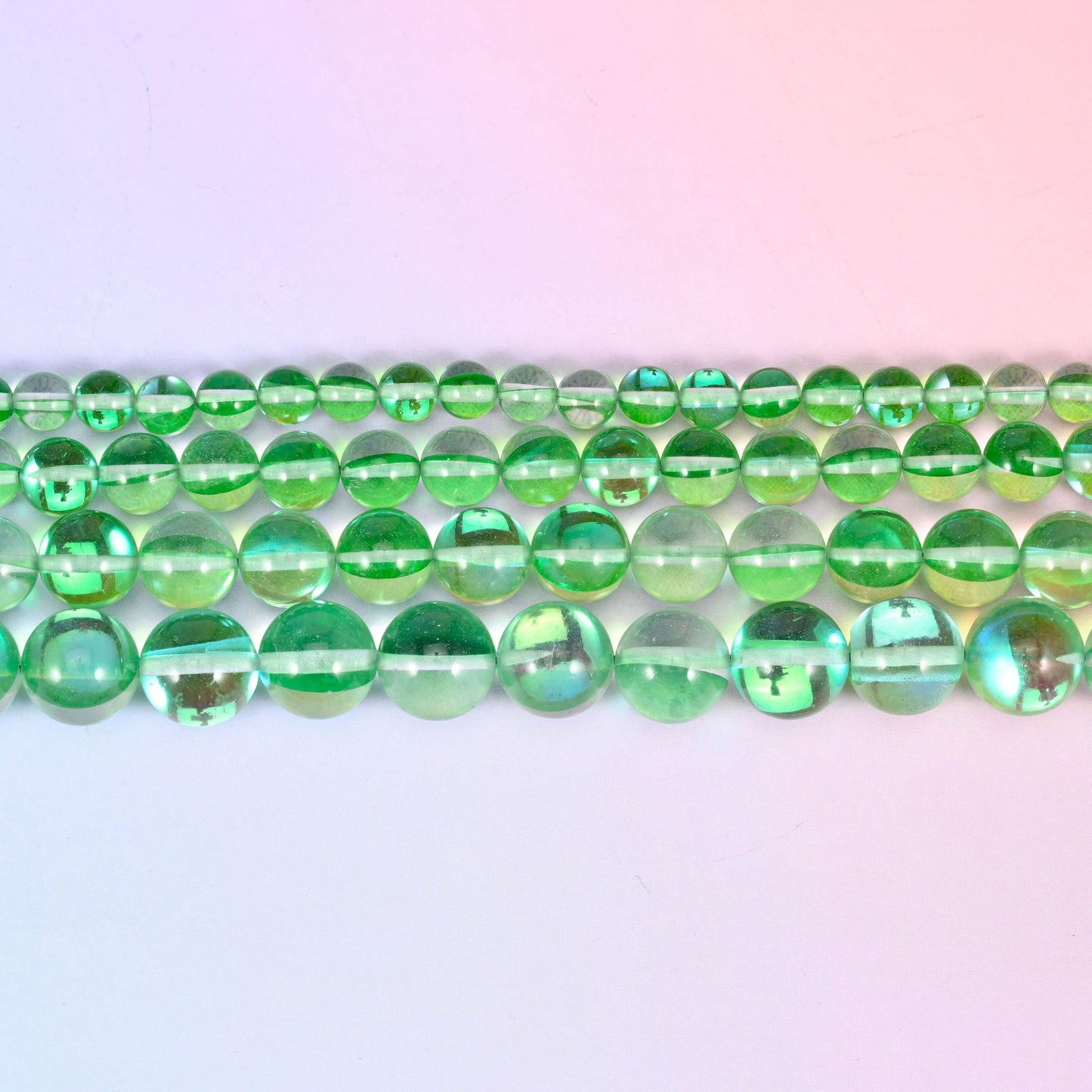 Mystic Aura beads in apple-green iridescent glass with aqua and gold flashes