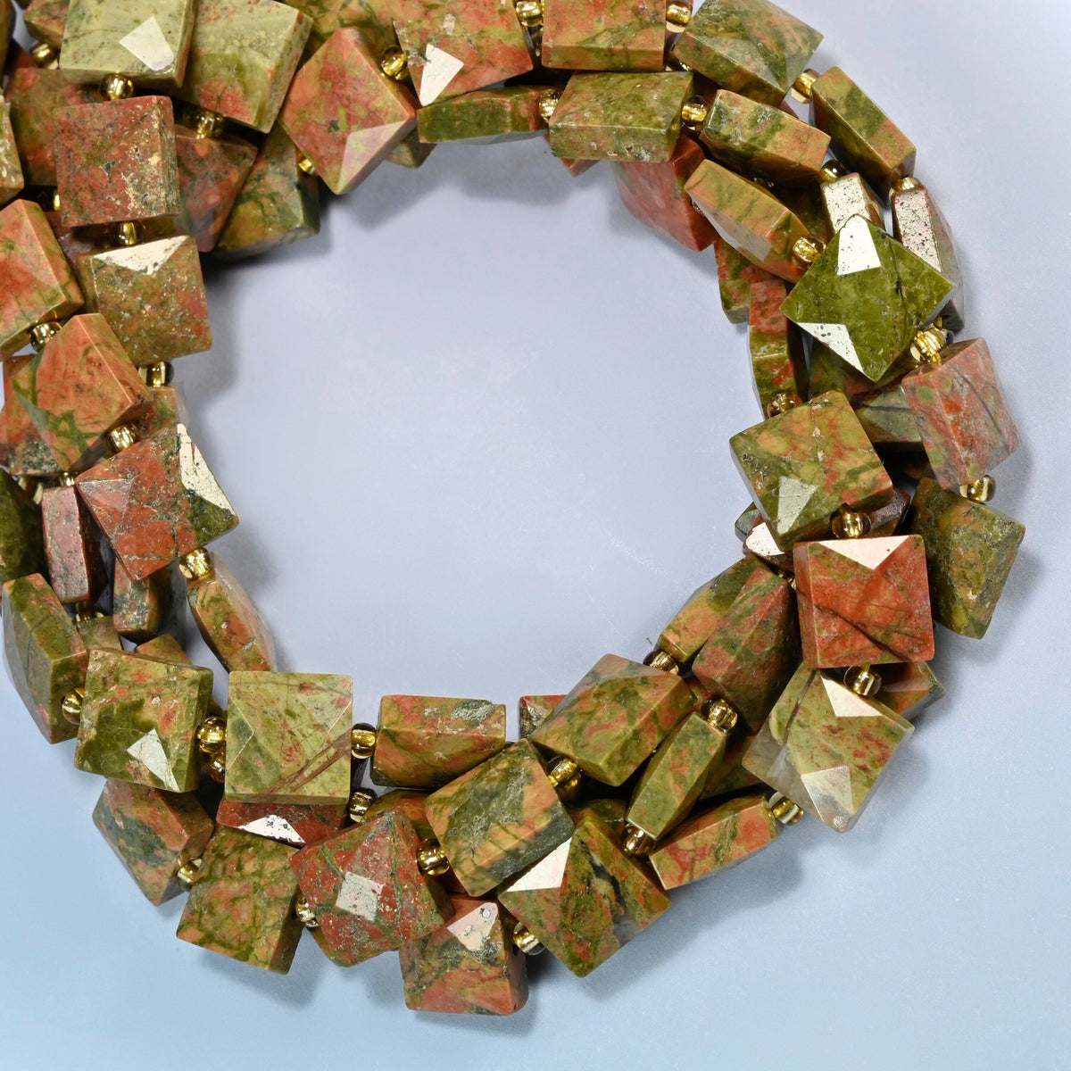 Natural unakite faceted flat square beads coiled into overlapping loops, whole strands of green and pink stone