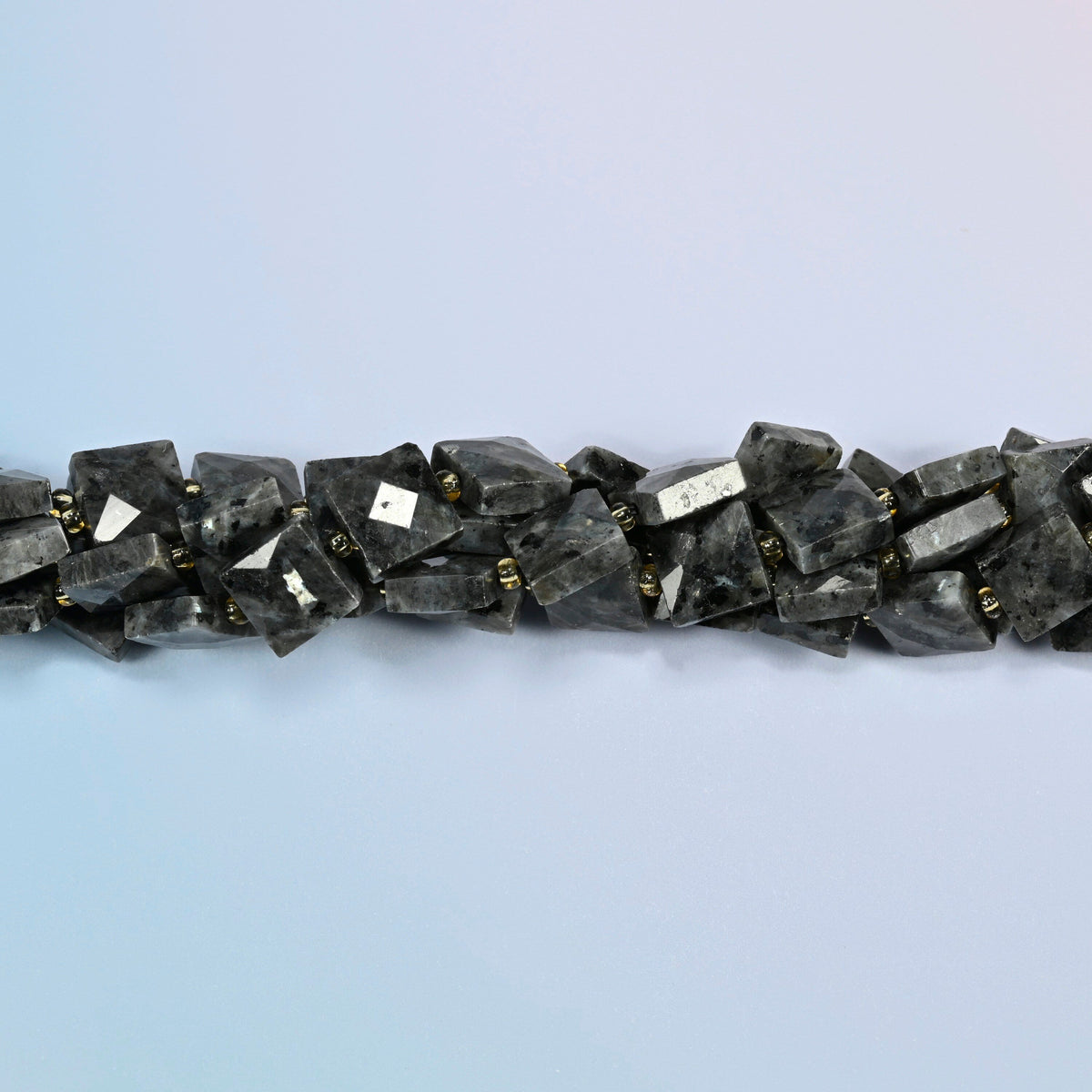 Strands of natural black labradorite faceted flat square beads twisted together in a horizontal row