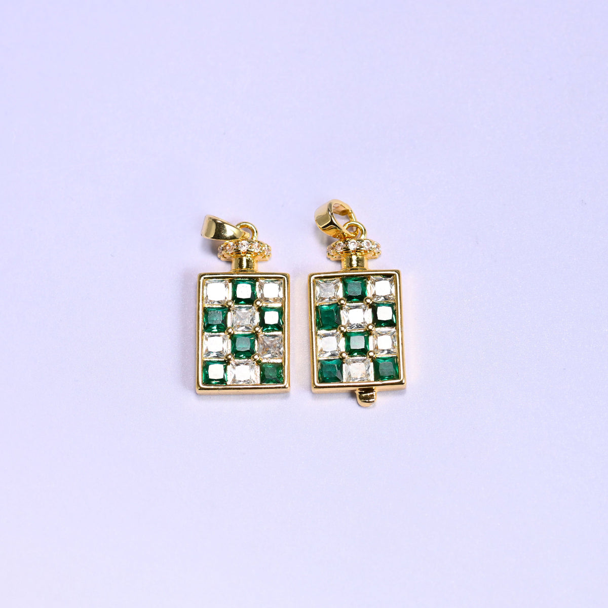Green checkerboard version of the perfume bottle zirconia charm, two 18K gold plated pendants side by side, one turned slightly to show the bottle side profile.
