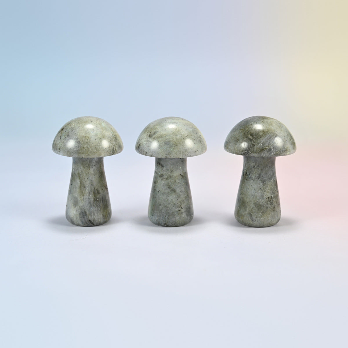 Three 2 inch gray labradorite mushroom crystal carvings, gray-green natural stone with a soft sheen