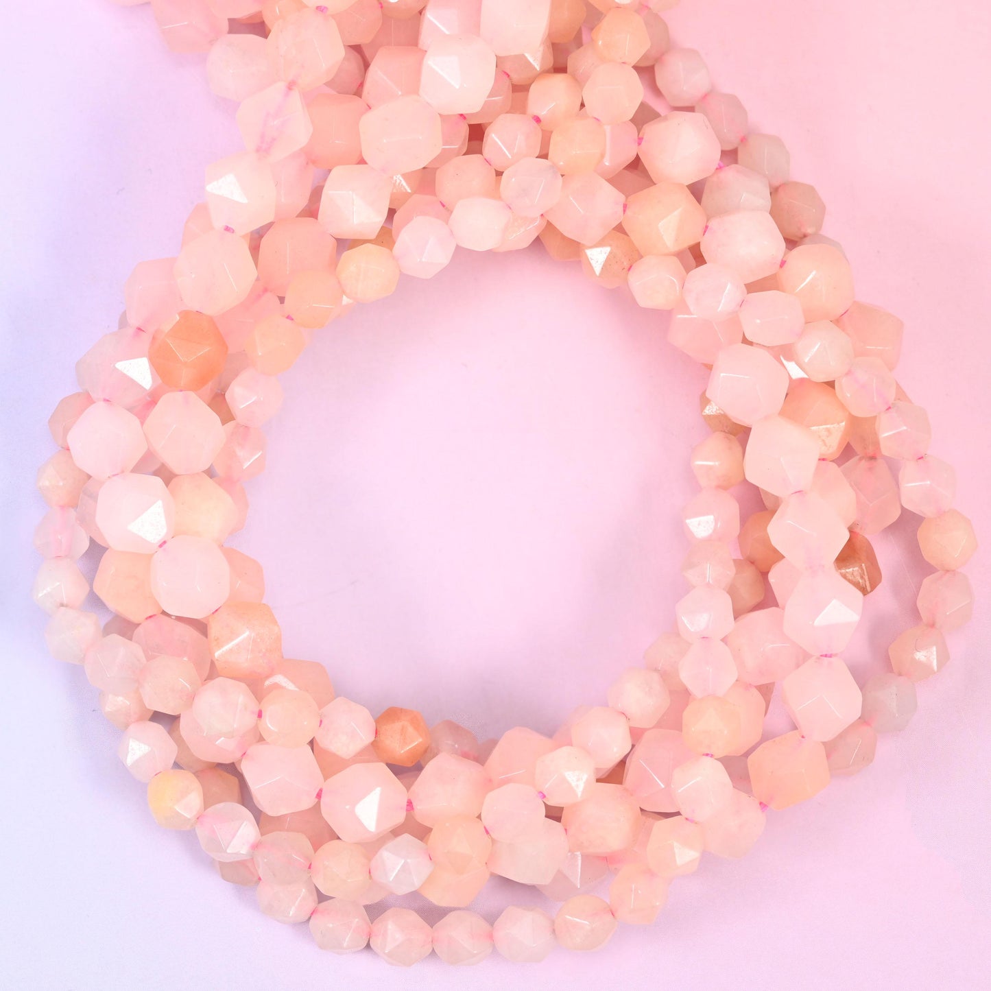 Pink Aventurine star cut beads coiled in a loop, approximately 38 beads per 10mm strand