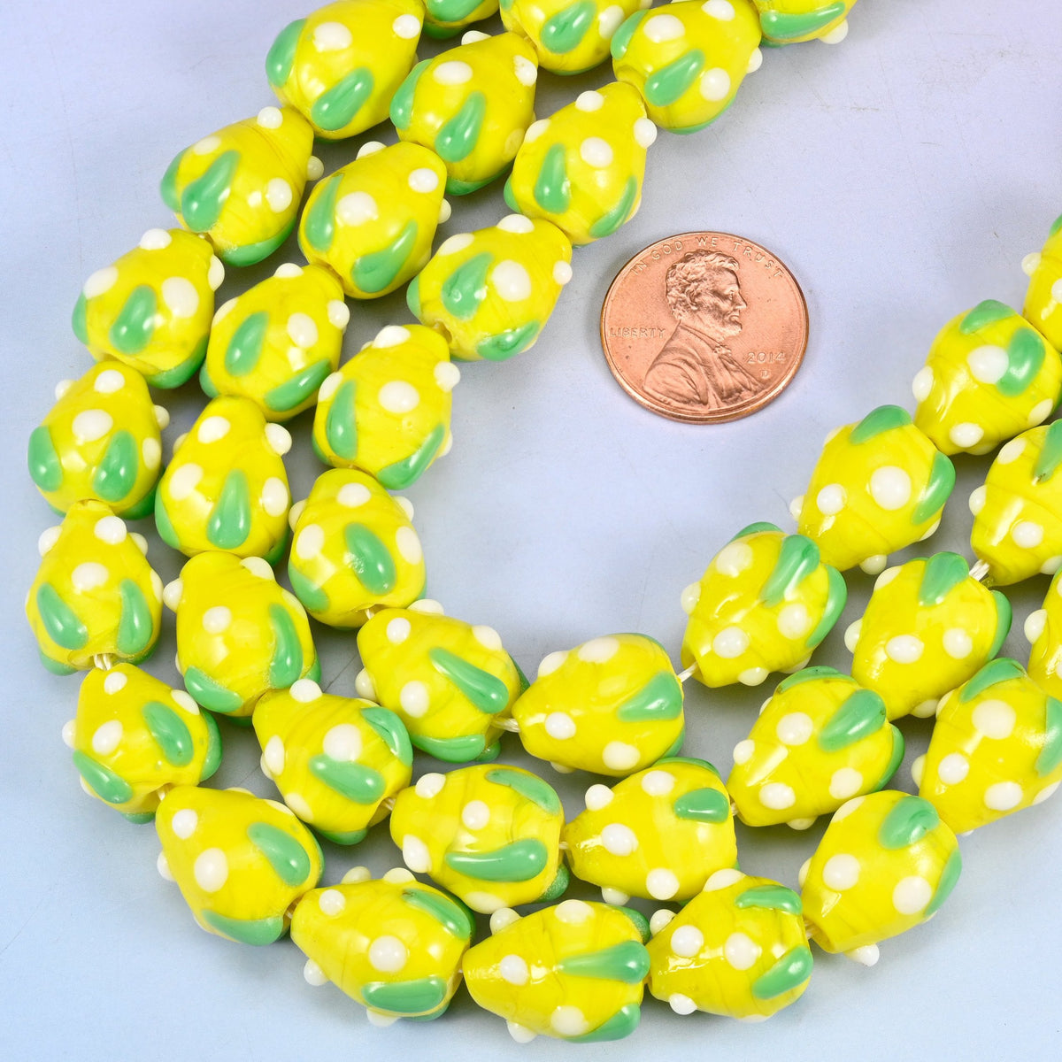 Strawberry shaped glass beads speckled with white seed dots