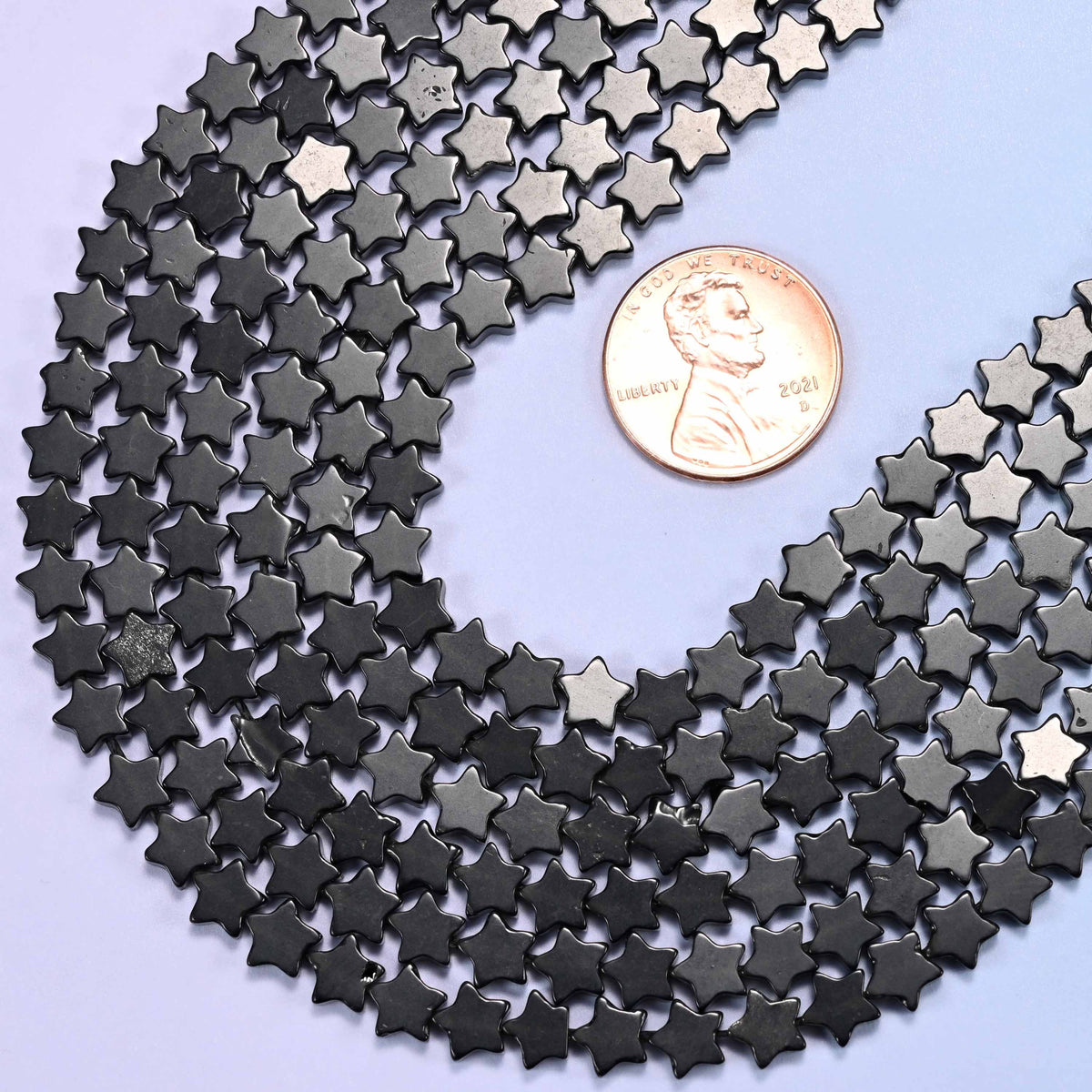 Flat five-pointed star cut black obsidian beads