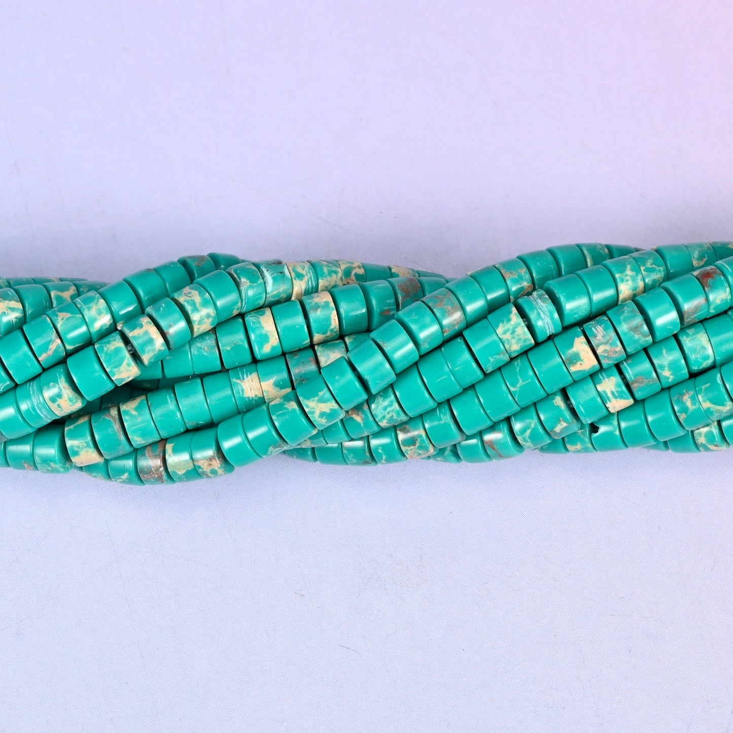 Green Shoushan Stone smooth heishi disc beads (dyed) in turquoise-green with cream and rust mottling, finished with a polished, sophisticated look.