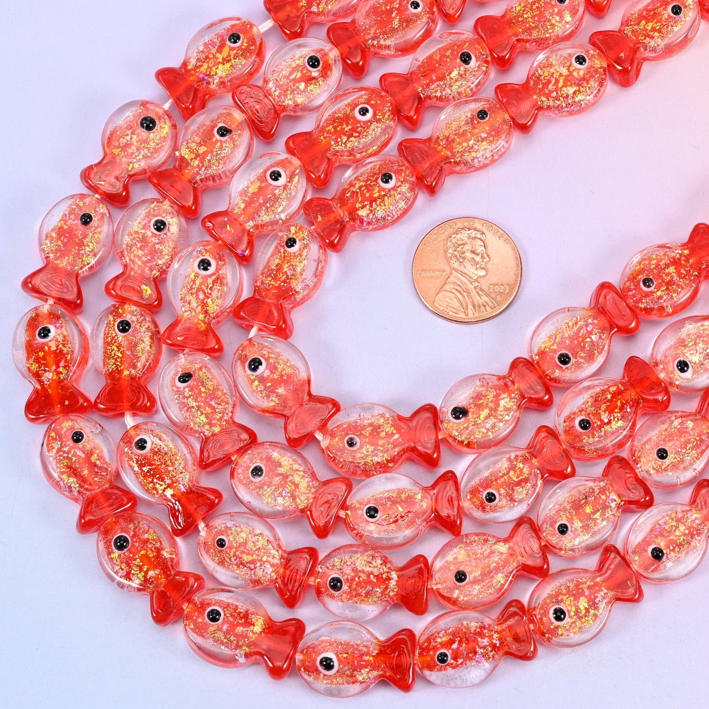 Fish shaped red glitter glass beads