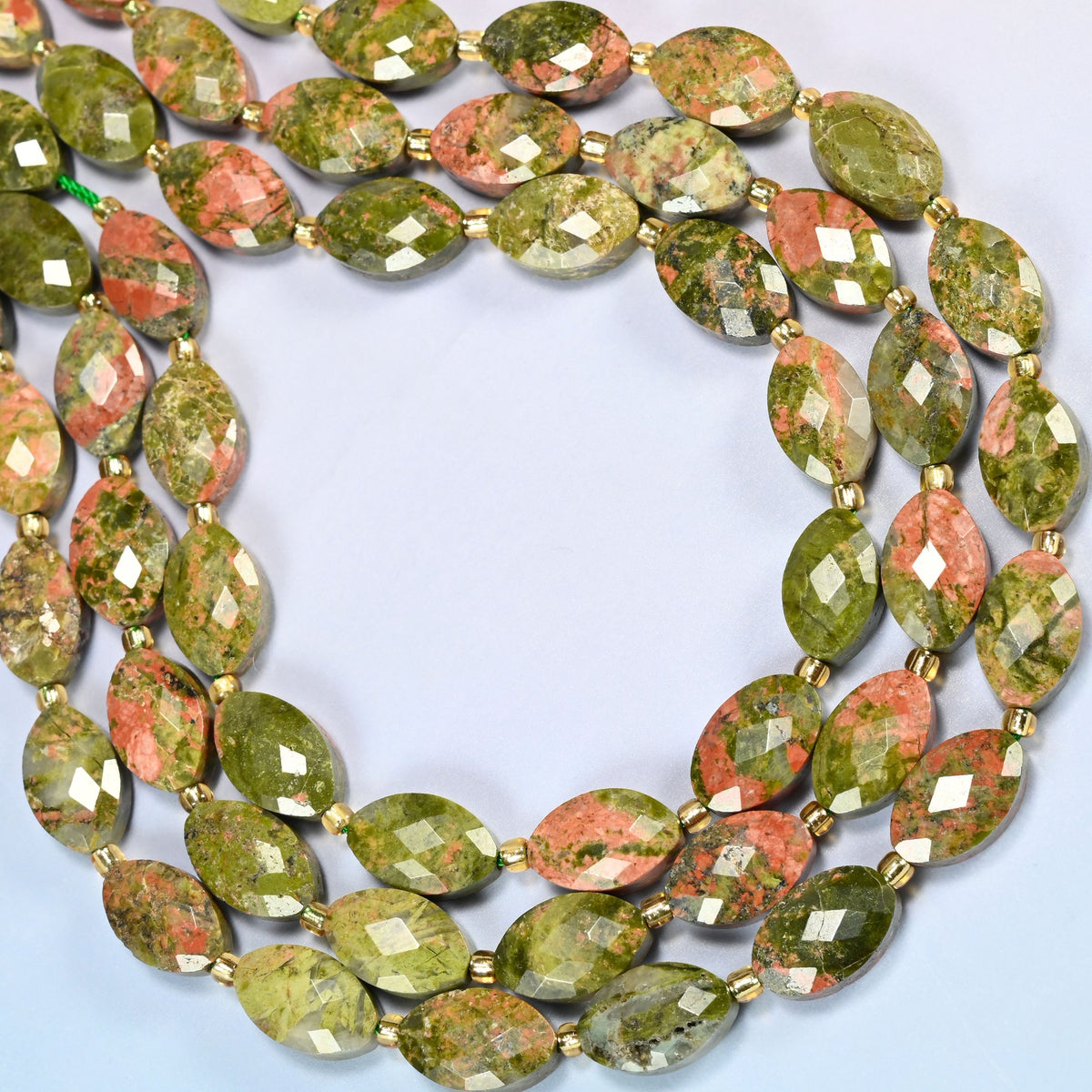 Unakite faceted flat oval beads curved into an open loop, green and pink beads