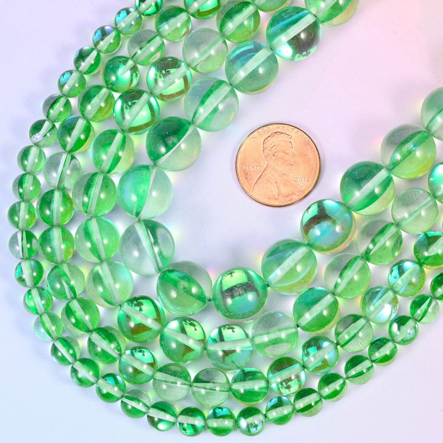 Round iridescent green glass beads with mirrored aura coating