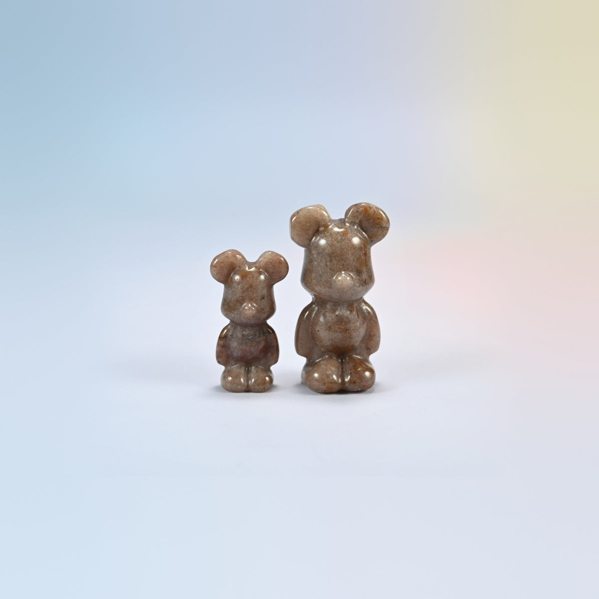 A 1.5 inch and a 2 inch strawberry quartz power bear crystal carving, brown-pink natural stone with dark speckles