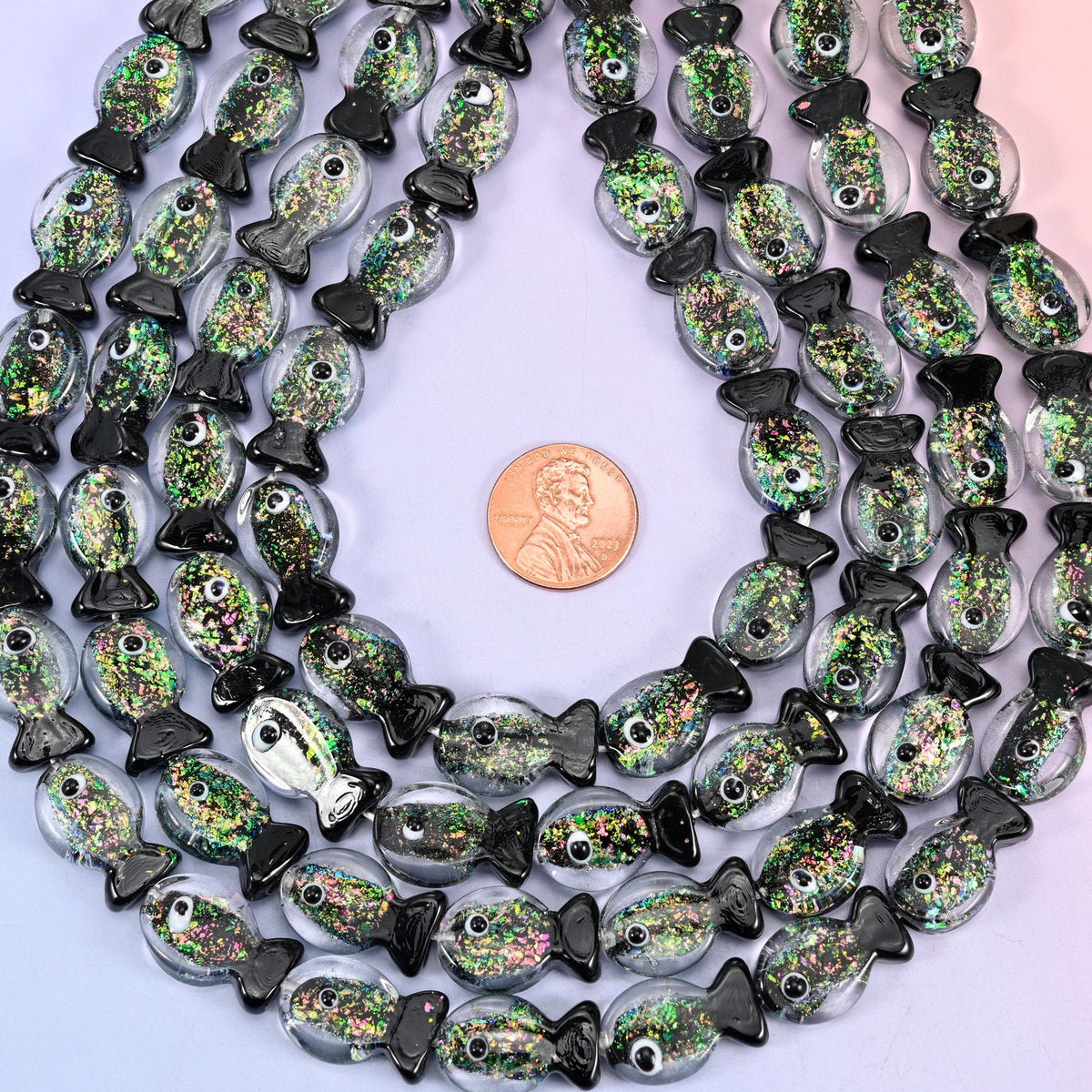 Fish shaped iridescent black green glass beads