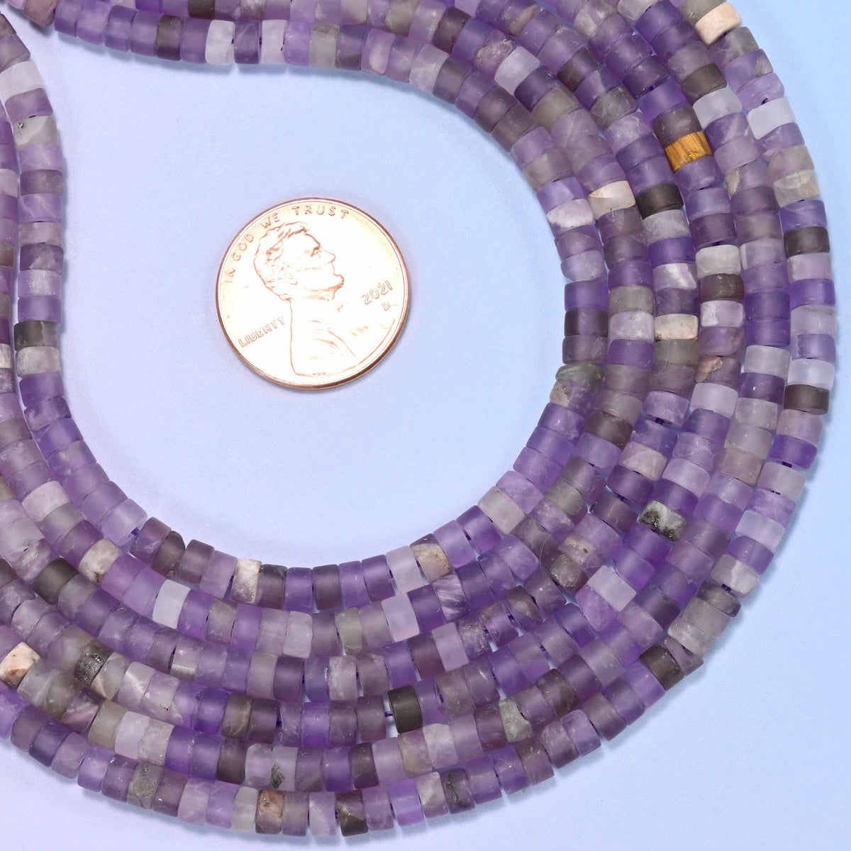 Natural amethyst matte heishi disc beads in rich purple tones from deep violet to soft lavender.