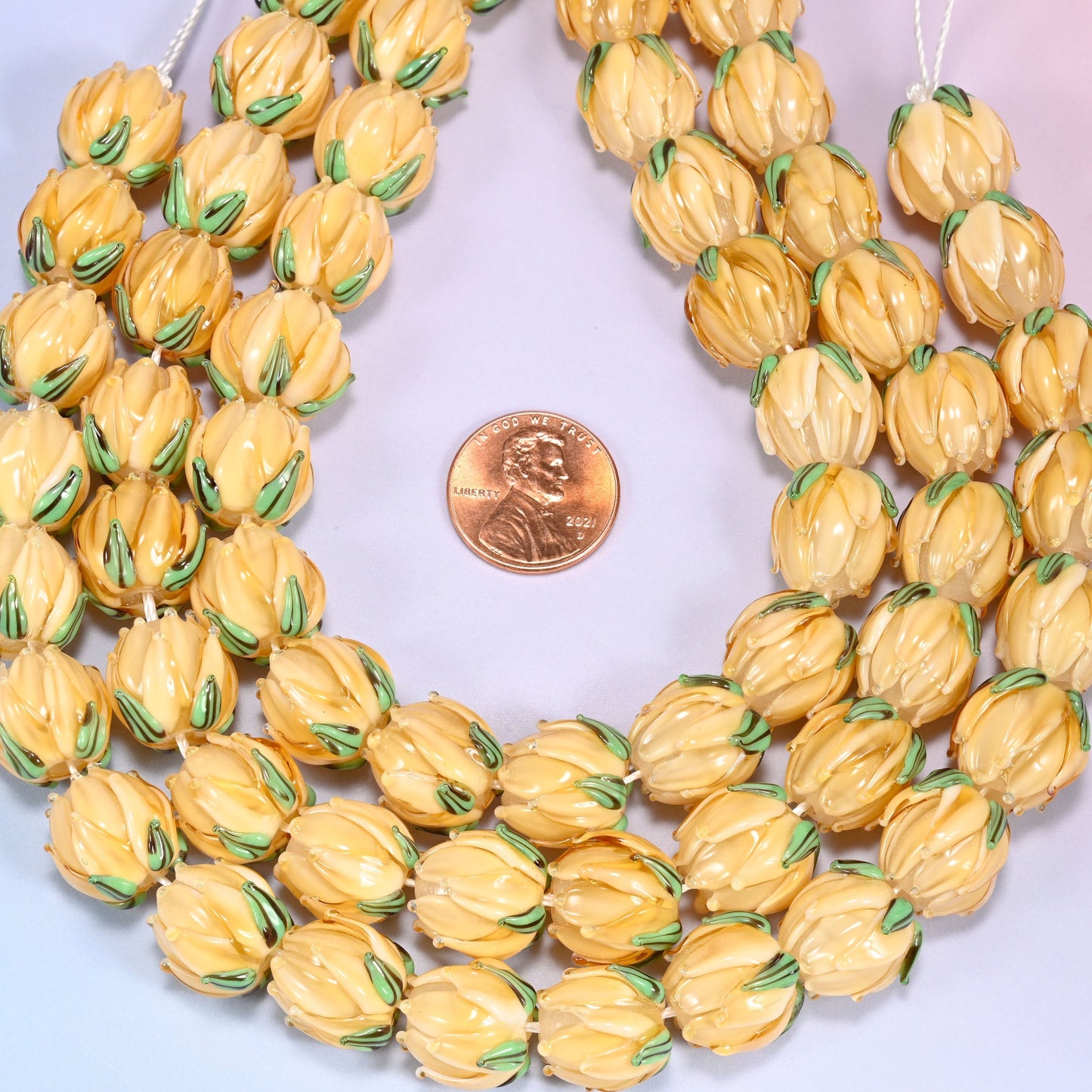 Creamy yellow tulip flower bud lampwork glass beads, approximately 20 beads per strand