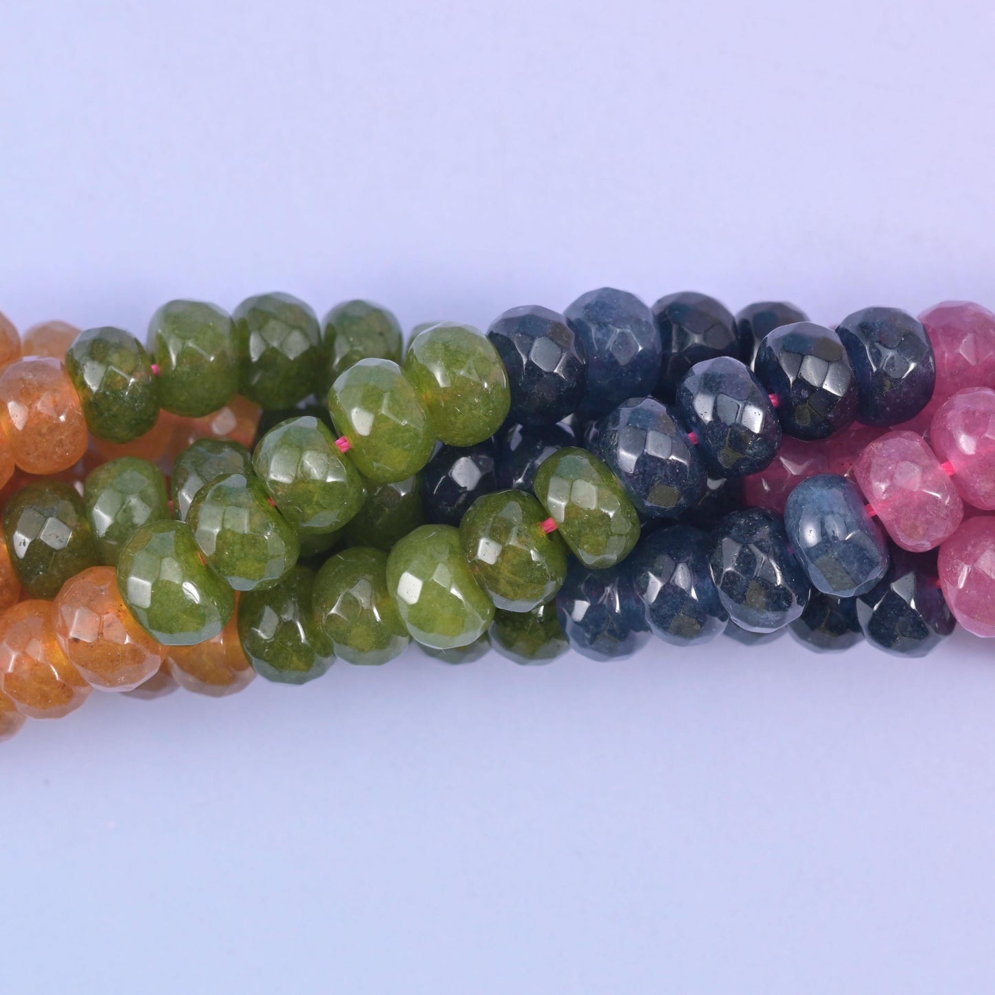Faceted rondelle cut dyed jade beads with a graded, watermelon-tourmaline style colour run