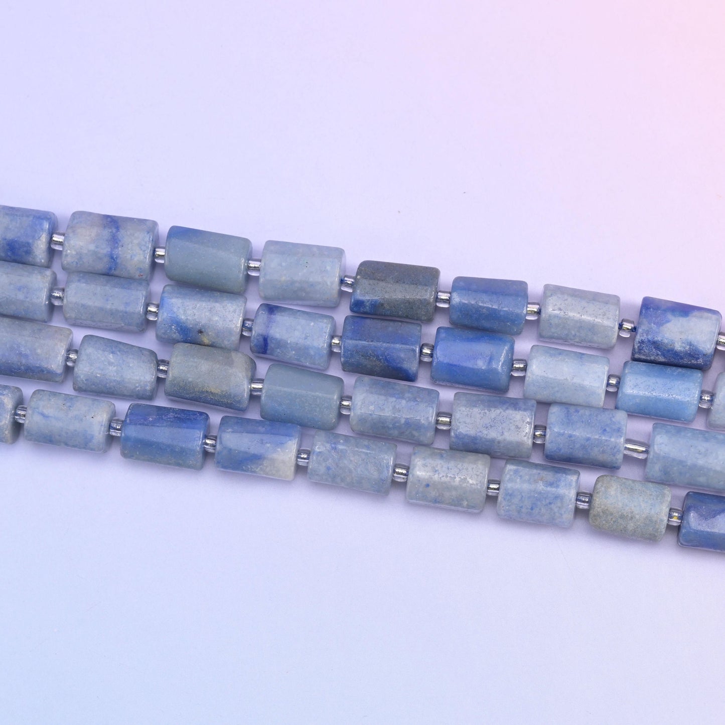 Strands of 12x8mm aventurine tubes laid diagonally, silver spacers between every bead