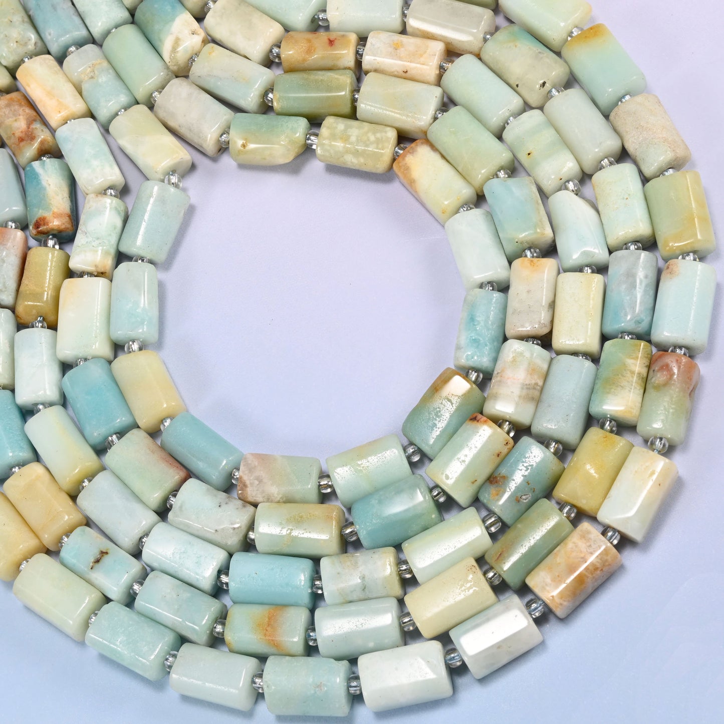 Multi-Color Amazonite faceted tube beads coiled in a full loop, a 15.5 inch strand holding roughly 29 beads