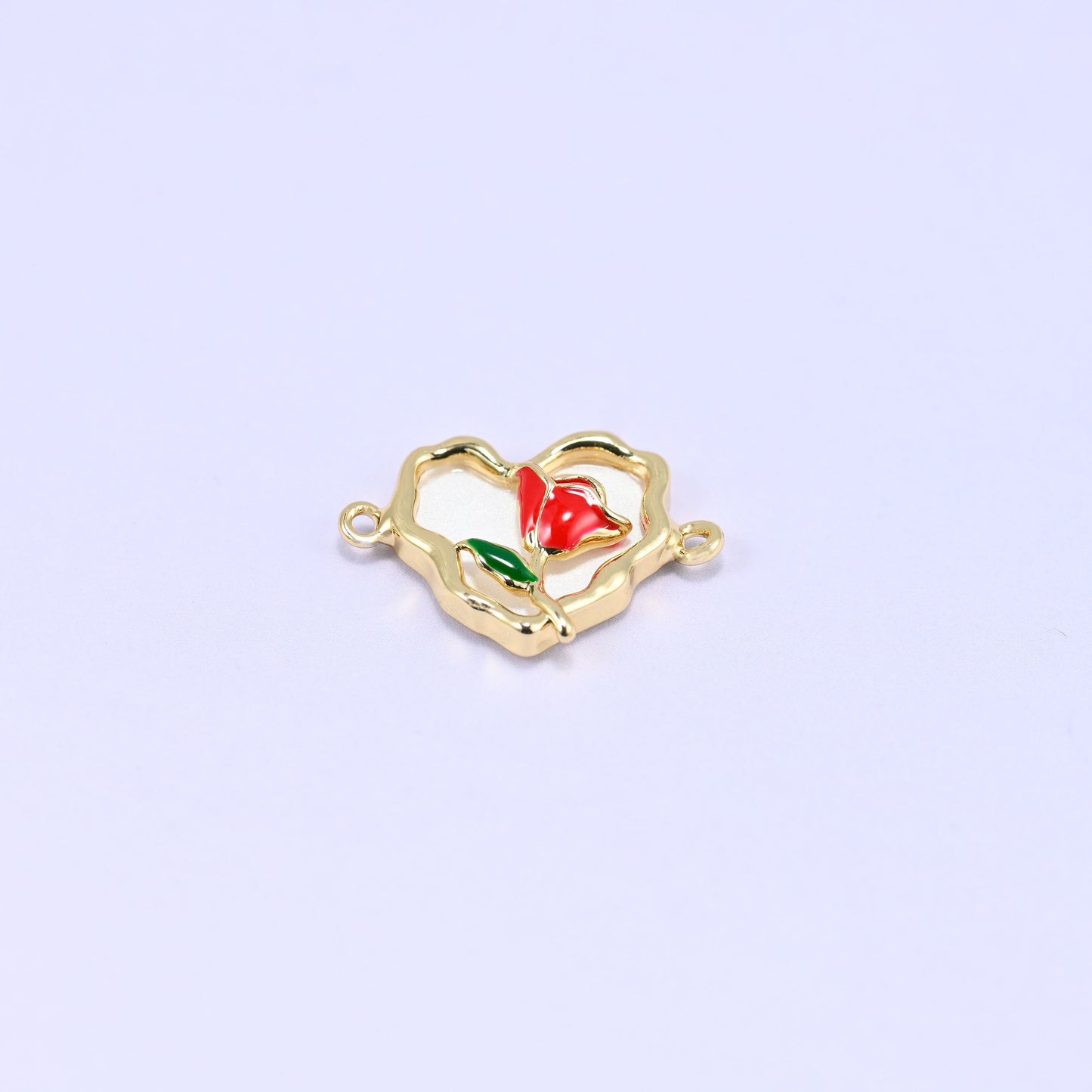 Cream-white enamel heart in an open scalloped 18K gold plated frame with a red enamel rose