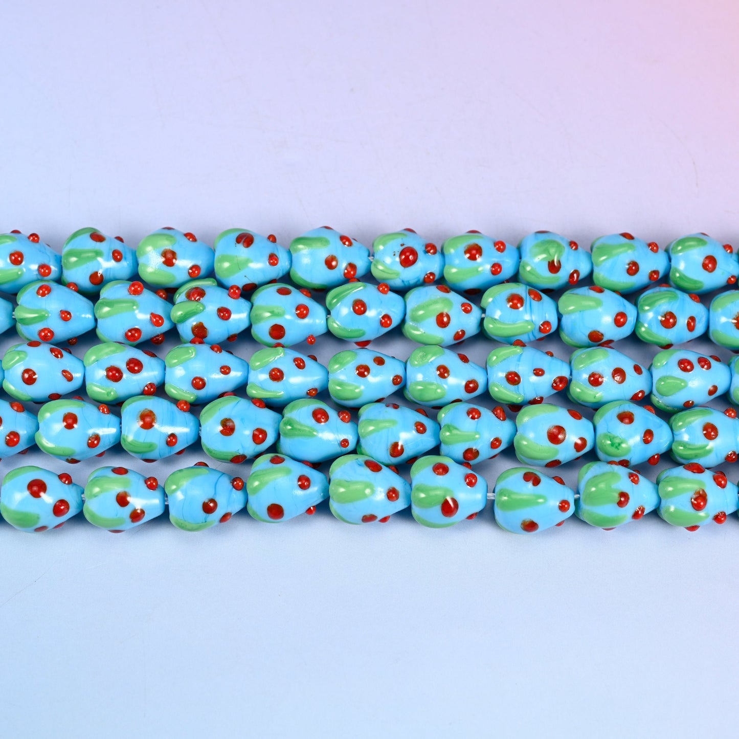 Sky Blue Strawberry Glass Beads 15.5x12mm in sky blue with red dots and a green leaf