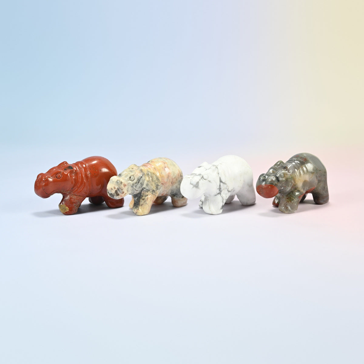 Four 2 inch hippo crystal carvings in natural red jasper, crazy agate, white howlite and African bloodstone