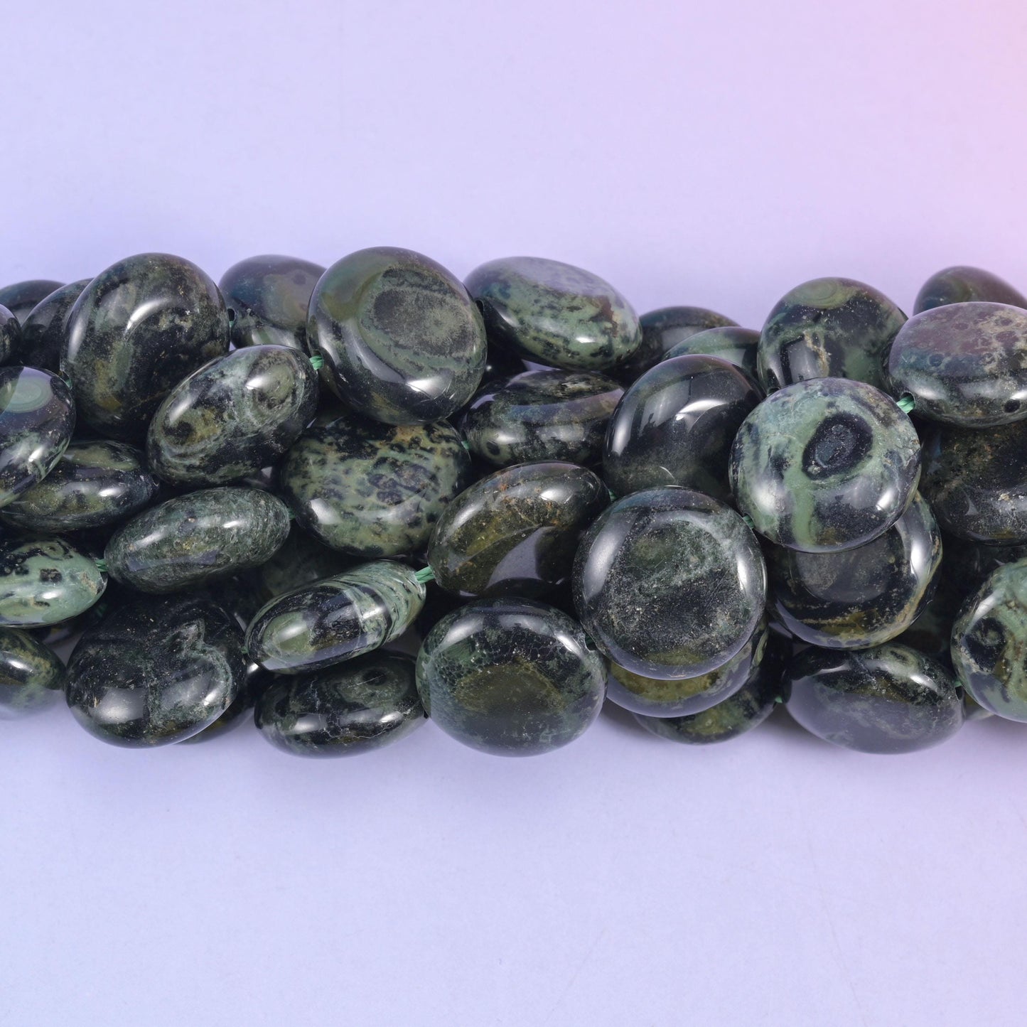 Coin cut Kambaba Jasper beads with a wet-looking glossy polish
