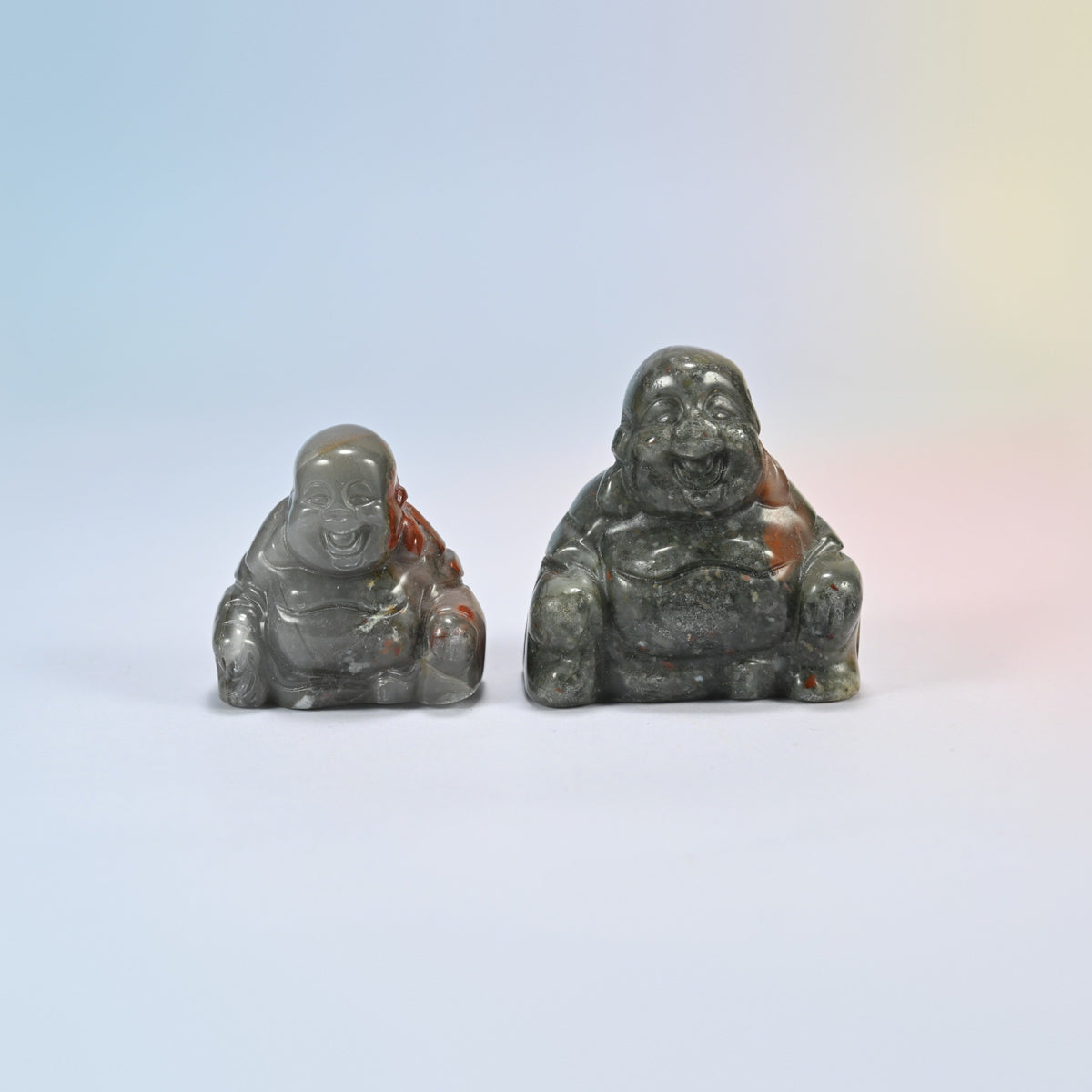 A 1.5 inch and a 2 inch African bloodstone laughing Buddha crystal carving, gray-green natural stone with red patches